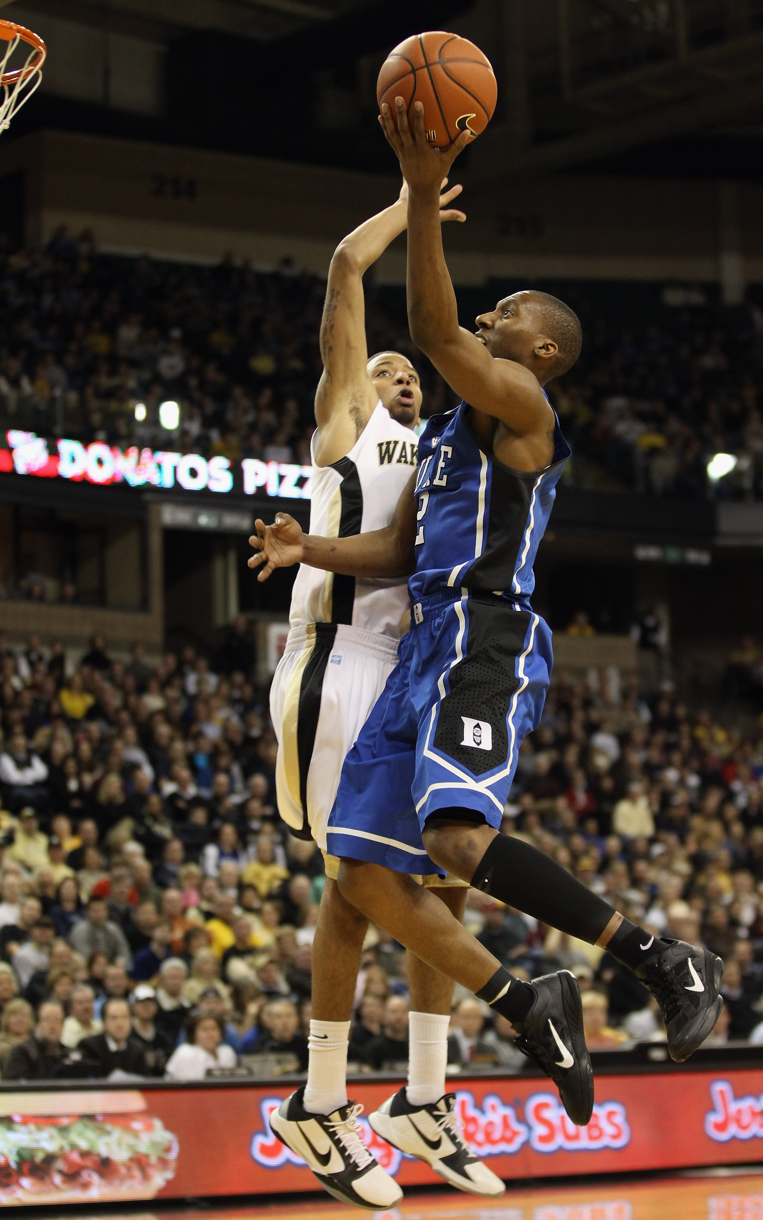 WINSTON SALEM, NC - JANUARY 22:  Nolan Smith #2 of the Duke Blue Devils drives to the basket against J.T. Terrell  #0 of the Wake Forest Demon Deacons during their game at Lawrence Joel Coliseum on January 22, 2011 in Winston Salem, North Carolina.  (Phot