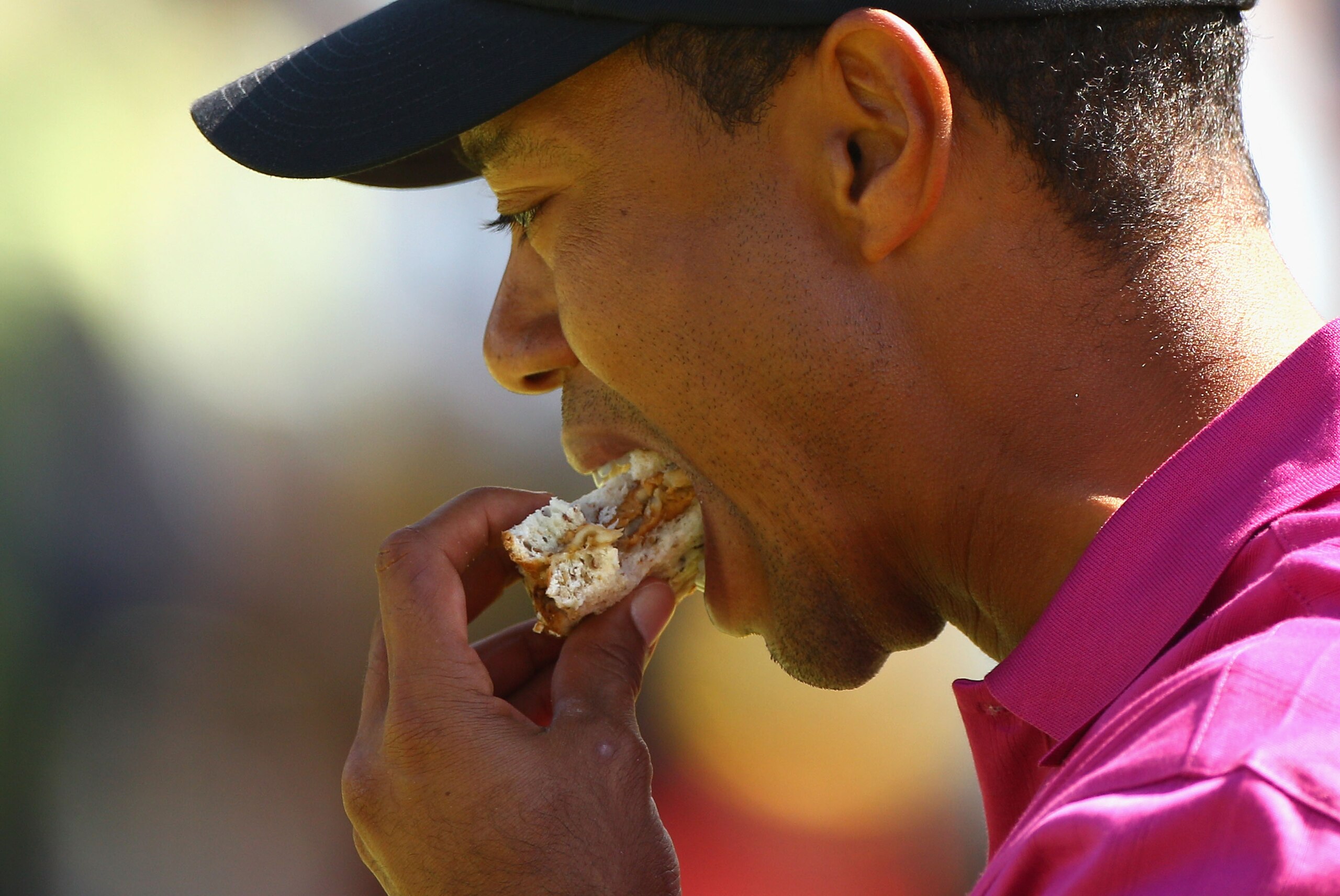 MELBOURNE, AUSTRALIA - NOVEMBER 11:  Tiger Woods of the USA eats a sandwich during day one of the Australian Masters at The Victoria Golf Club on November 11, 2010 in Melbourne, Australia.  (Photo by Ryan Pierse/Getty Images)