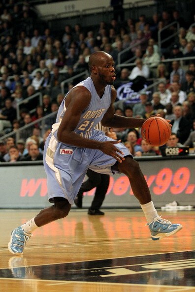 PROVIDENCE, RI - DECEMBER 04:  Delroy James #21 of the Rhode Island Rams brings the ball up court against the Providence Friars at the Dunkin' Donuts Center on December 4, 2010 in Providence, Rhode Island.  (Photo by Chris Chambers/Getty Images)
