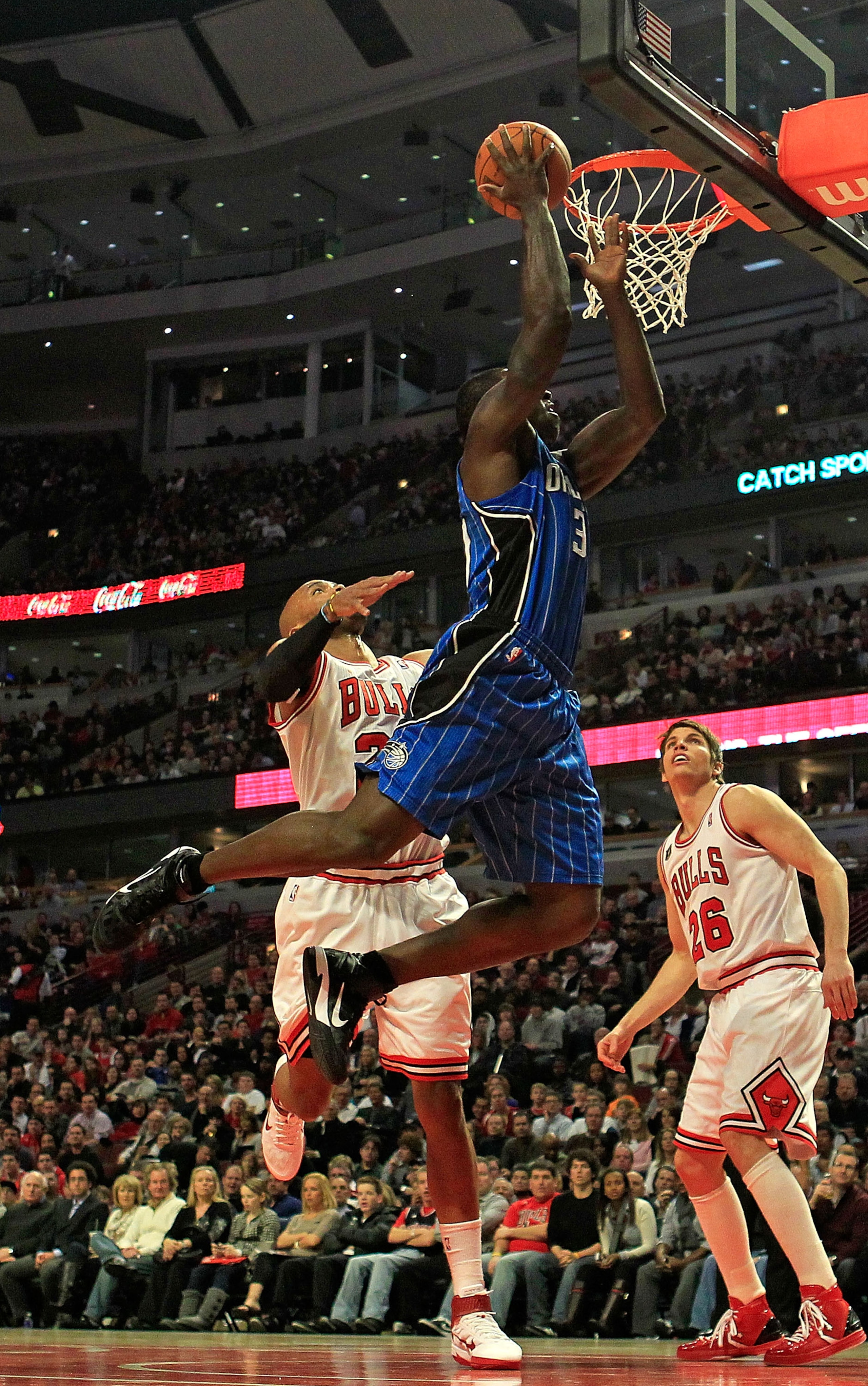 CHICAGO, IL - JANUARY 28: Brandon Bass #30 of the Orlando Magic goes up for a shot over Taj Gibson #22 and Kyle Korver #26 of the Chicago Bulls at the United Center on January 28, 2011 in Chicago, Illinois. NOTE TO USER: User expressly acknowledges and ag CHICAGO, IL - JANUARY 28: Brandon Bass #30 of the Orlando Magic goes up for a shot over Taj Gibson #22 and Kyle Korver #26 of the Chicago Bulls at the United Center on January 28, 2011 in Chicago, Illinois. NOTE TO USER: User expressly acknowledges and ag