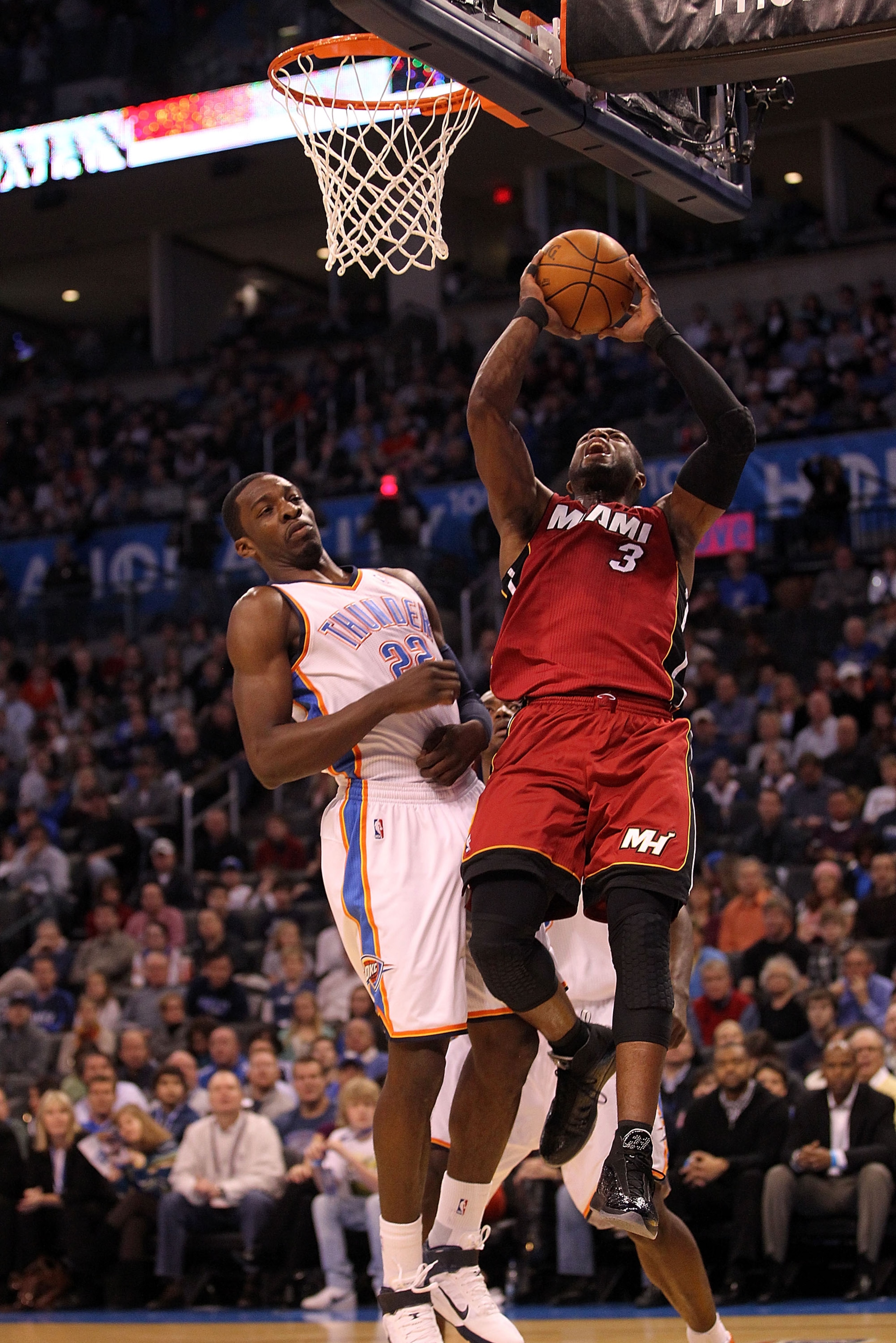 OKLAHOMA CITY, OK - JANUARY 30: Guard Dwyane Wade #3 of the Miami Heat takes a shot against Jeff Green #22 of the Oklahoma City Thunder at Ford Center on January 30, 2011 in Oklahoma City, Oklahoma. NOTE TO USER: User expressly acknowledges and agrees t OKLAHOMA CITY, OK - JANUARY 30: Guard Dwyane Wade #3 of the Miami Heat takes a shot against Jeff Green #22 of the Oklahoma City Thunder at Ford Center on January 30, 2011 in Oklahoma City, Oklahoma. NOTE TO USER: User expressly acknowledges and agrees t