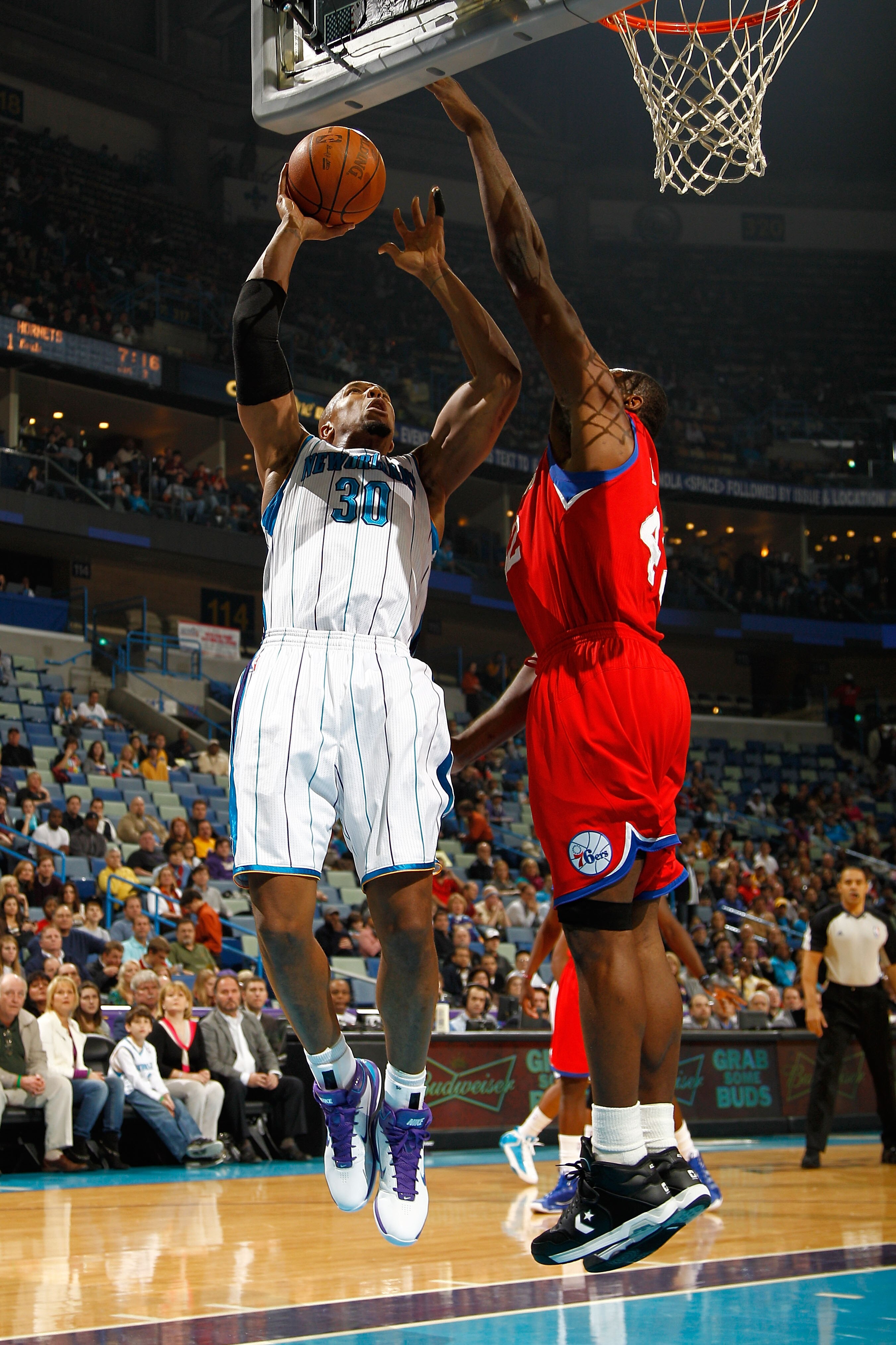 NEW ORLEANS, LA - JANUARY 03:  David West #30 of the New Orleans Hornets shoots over Elton Brand #42 of the Philadelphia 76ers in the first half at New Orleans Arena on January 3, 2011 in New Orleans, Louisiana. NOTE TO USER: User expressly acknowledges a