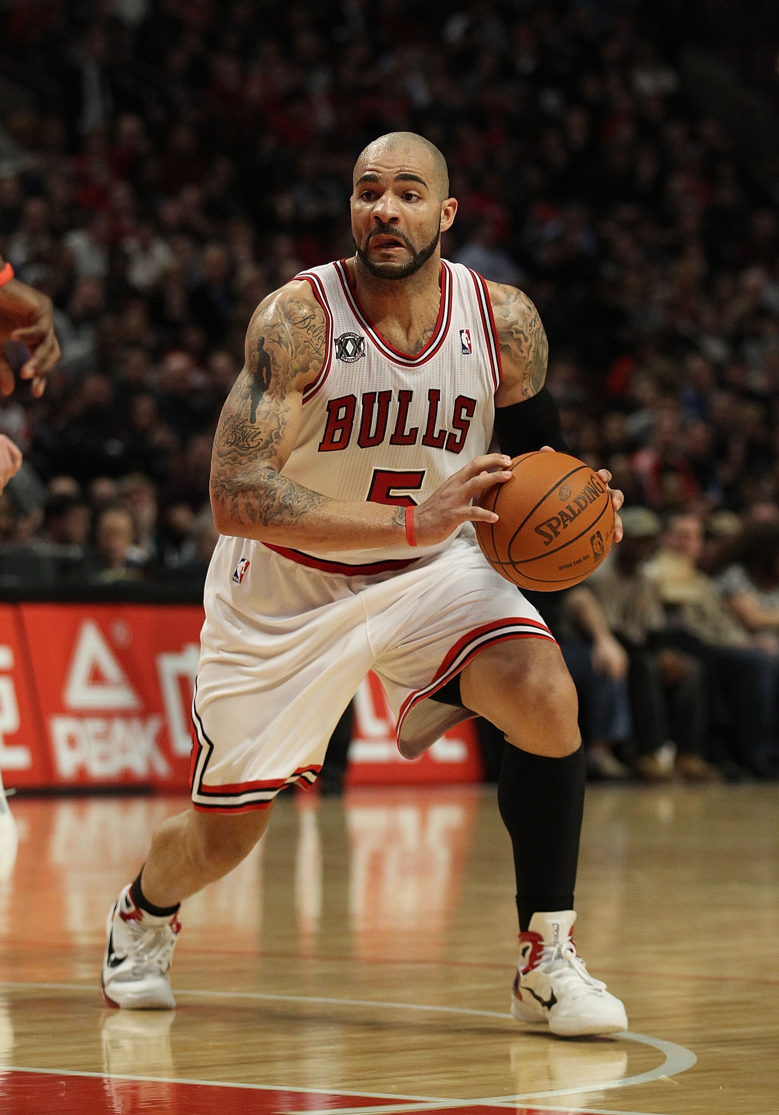 CHICAGO, IL - JANUARY 28: Carlos Boozer #5 of the Chicago Bulls looks to pass against the Orlando Magic at the United Center on January 28, 2011 in Chicago, Illinois. The Bulls defeated the Magic 99-90. NOTE TO USER: User expressly acknowledges and agrees CHICAGO, IL - JANUARY 28: Carlos Boozer #5 of the Chicago Bulls looks to pass against the Orlando Magic at the United Center on January 28, 2011 in Chicago, Illinois. The Bulls defeated the Magic 99-90. NOTE TO USER: User expressly acknowledges and agrees