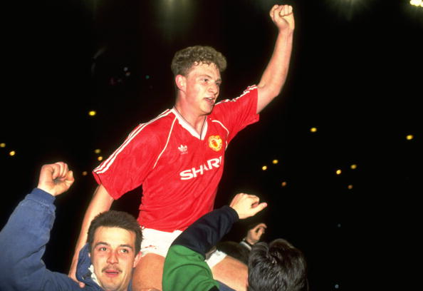 1990:  Mark Robins (centre) of Manchester United on the shoulders of two supporter after they win the FA Cup Semi-Final Replay against Oldham at Maine Road in Manchester, England. \ Mandatory Credit: Dan  Smith/Allsport