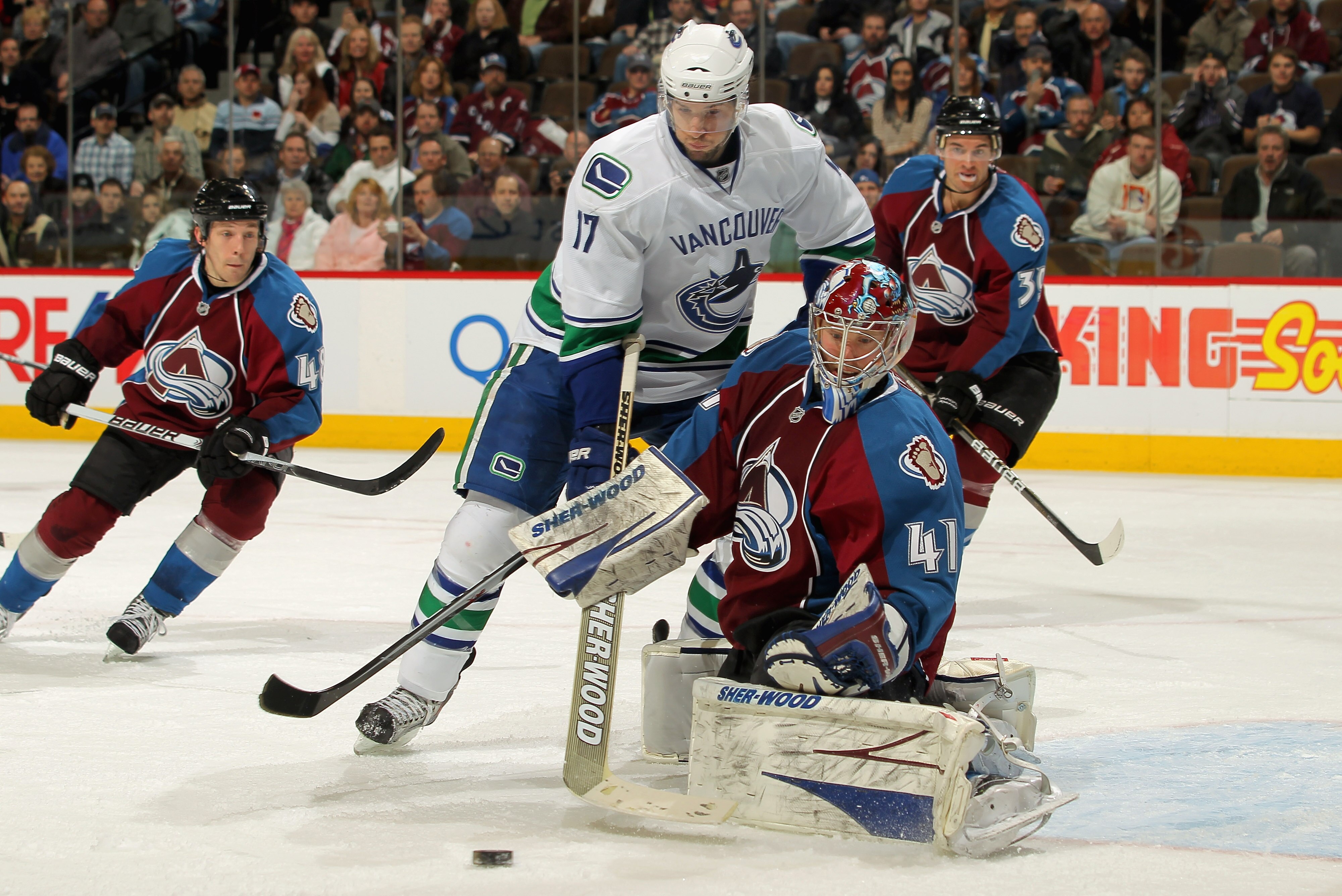 DENVER, CO - JANUARY 18:  Goalie Craig Anderson #41 of the Colorado Avalanche deflects the puck and makes a save as Ryan Kesler #17 of the Vancouver Canucks looks for the rebound at the Pepsi Center on January 18, 2011 in Denver, Colorado. Anderson had 40