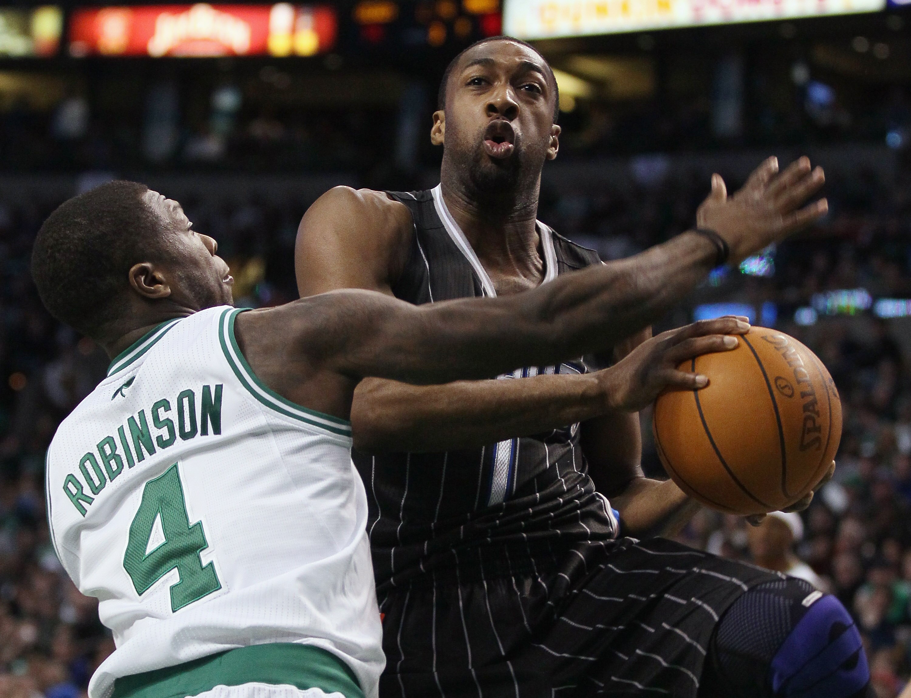 BOSTON, MA - JANUARY 17:   Gilbert Arenas #1 of the Orlando Magic heads for the basket as Nate Robinson #4 of the Boston Celtics defends on January 17, 2011 at the TD Garden in Boston, Massachusetts. The Celtics defeated the Magic 109-106.  NOTE TO USER: