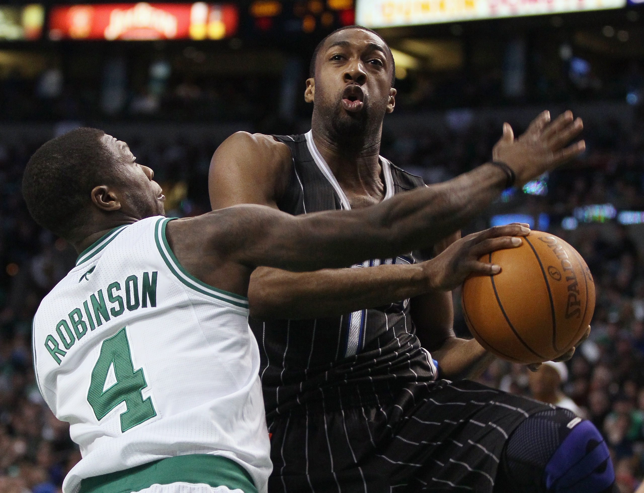 BOSTON, MA - JANUARY 17: Gilbert Arenas #1 of the Orlando Magic heads for the basket as Nate Robinson #4 of the Boston Celtics defends on January 17, 2011 at the TD Garden in Boston, Massachusetts. The Celtics defeated the Magic 109-106. NOTE TO USER: BOSTON, MA - JANUARY 17: Gilbert Arenas #1 of the Orlando Magic heads for the basket as Nate Robinson #4 of the Boston Celtics defends on January 17, 2011 at the TD Garden in Boston, Massachusetts. The Celtics defeated the Magic 109-106. NOTE TO USER: