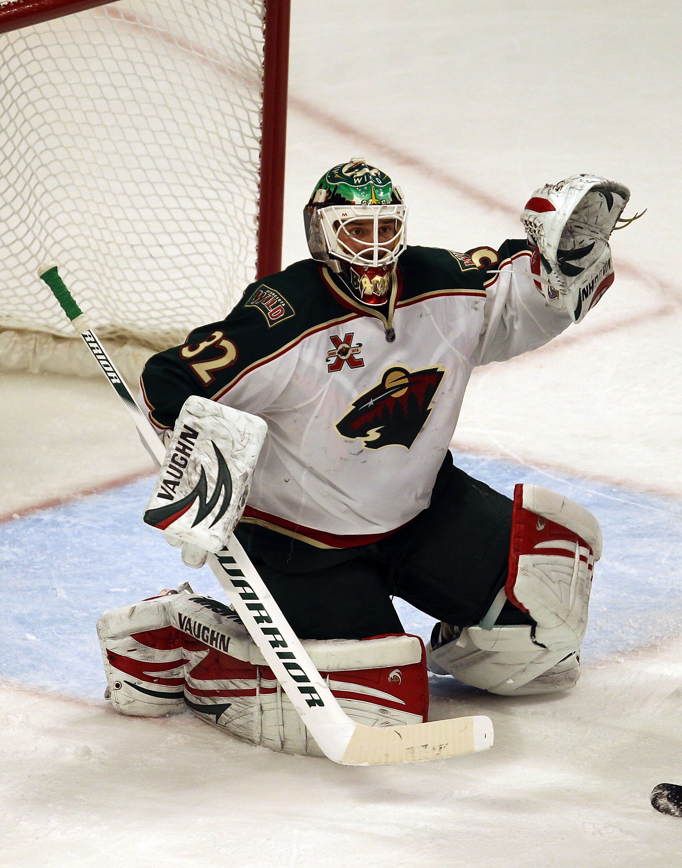 CHICAGO, IL - JANUARY 25: Niklas Backstrom #32 of the Minnesota Wild raises his glove as he protects the goal against the Chicago Blackhawks at the United Center on January 25, 2011 in Chicago, Illinois. The Wild defeated the Blackhawks 4-2.  (Photo by Jo