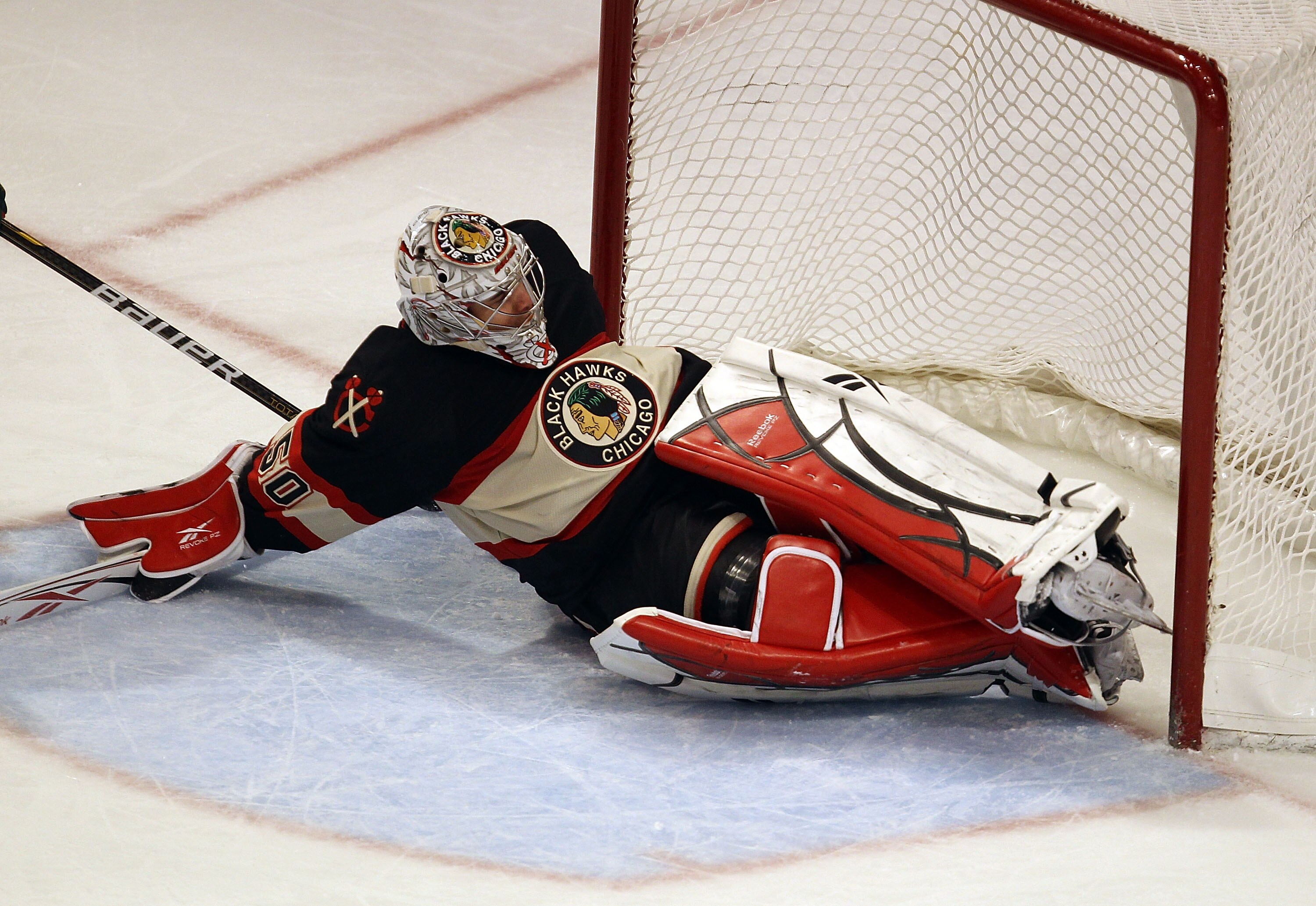 CHICAGO, IL - JANUARY 25: Corey Crawford #50 of the Chicago Blackhawks dives to stop the puck against the Minnesota Wild at the United Center on January 25, 2011 in Chicago, Illinois. The Wild defeated the Blackhawks 4-2. (Photo by Jonathan Daniel/Getty I