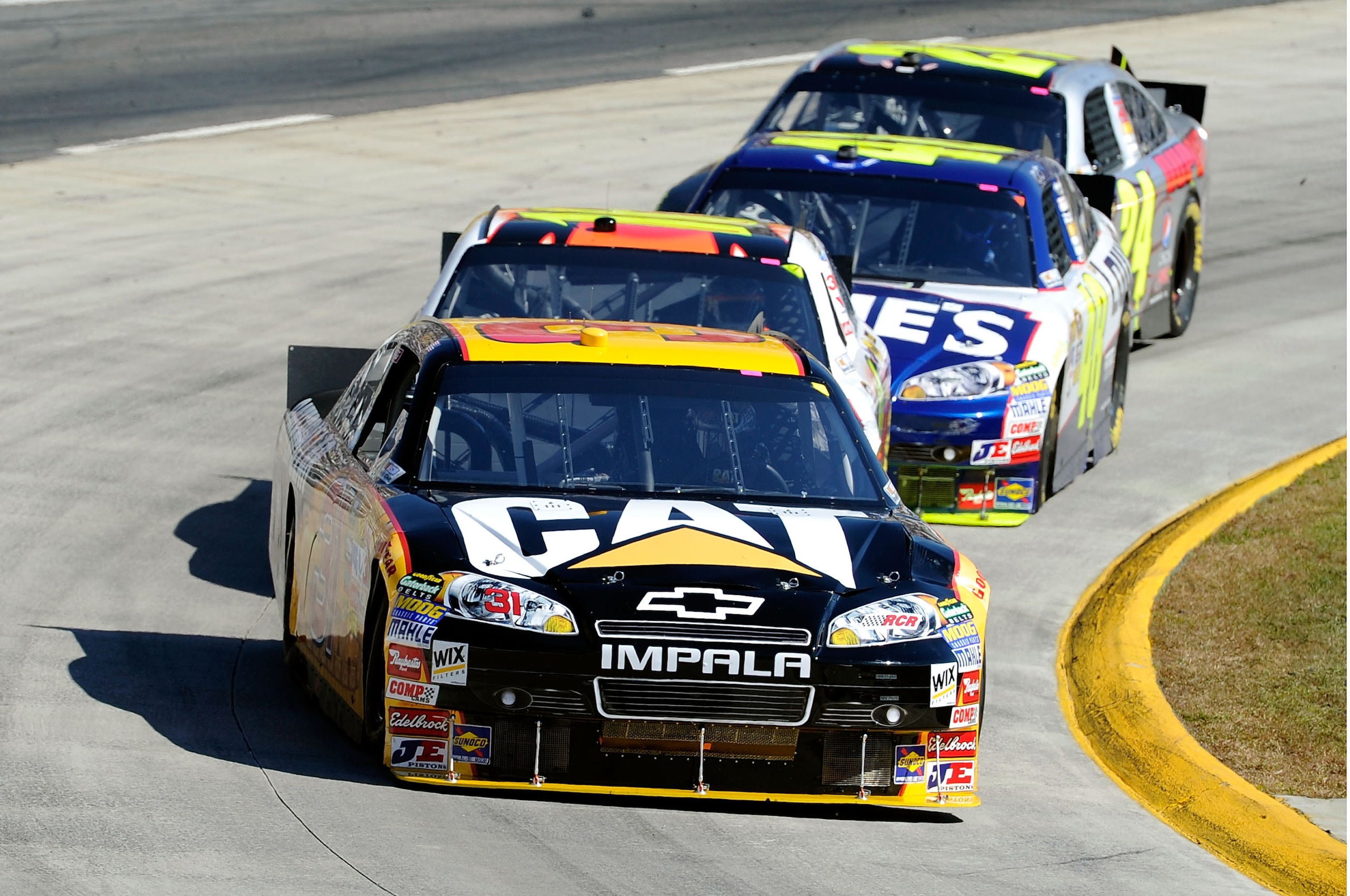 MARTINSVILLE, VA - OCTOBER 24: Jeff Burton, driver of the #31 Caterpilliar Chevrolet, leads Greg Biffle, driver of the #16 3M Ford, Jimmie Johnson, driver of the #48 Lowe's Chevrolet, and Jeff Gordon, driver of the #24 DuPont/National Guard Families Chev MARTINSVILLE, VA - OCTOBER 24: Jeff Burton, driver of the #31 Caterpilliar Chevrolet, leads Greg Biffle, driver of the #16 3M Ford, Jimmie Johnson, driver of the #48 Lowe's Chevrolet, and Jeff Gordon, driver of the #24 DuPont/National Guard Families Chev