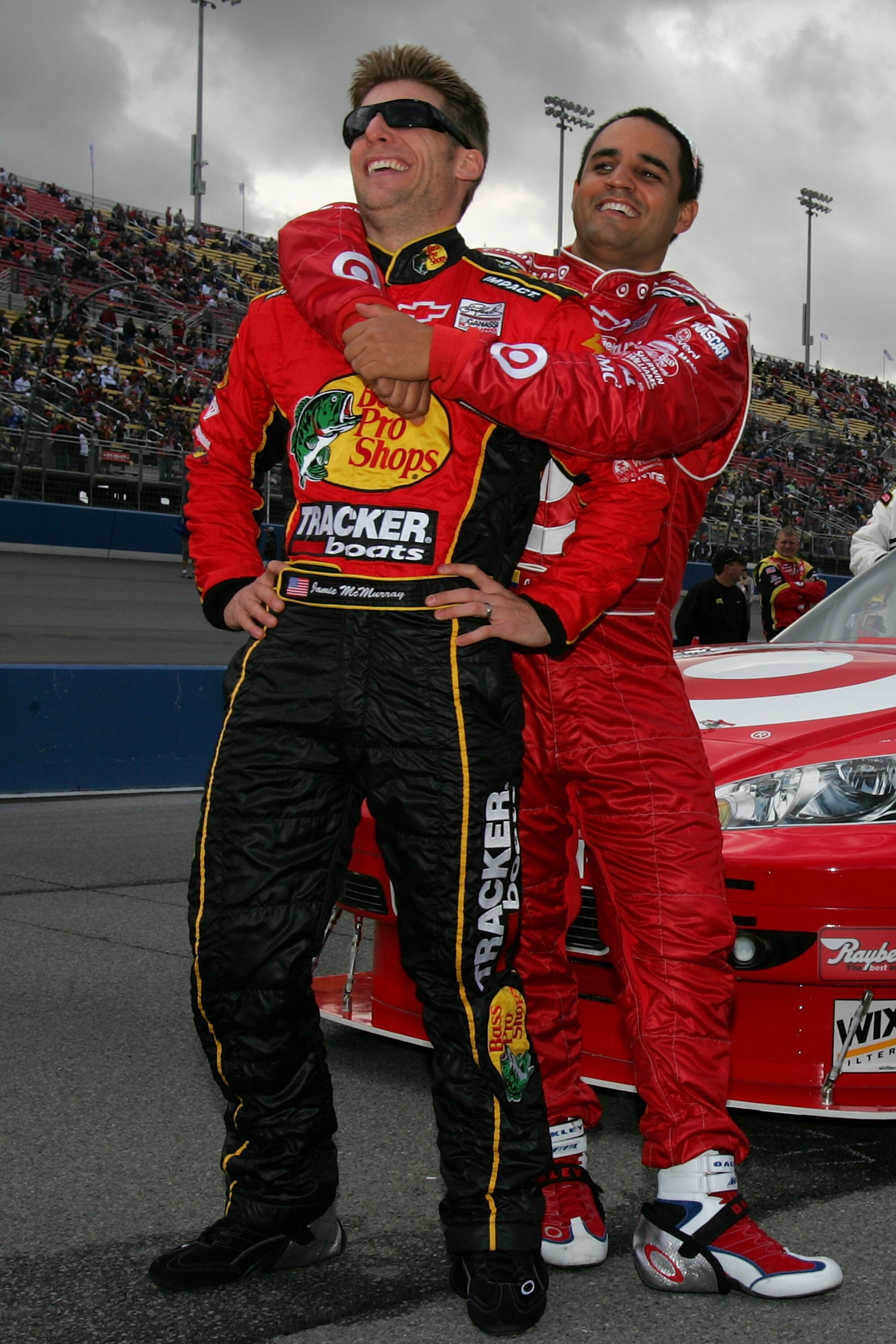 FONTANA, CA - FEBRUARY 21:  Juan Pablo Montoya, driver of the #42 Target Chevrolet, and Jamie McMurray, driver of the #1 Bass Pro Shops/Tracker Boats Chevrolet, share a light moment prior to the start of the NASCAR Sprint Cup Series Auto Club 500 at Auto