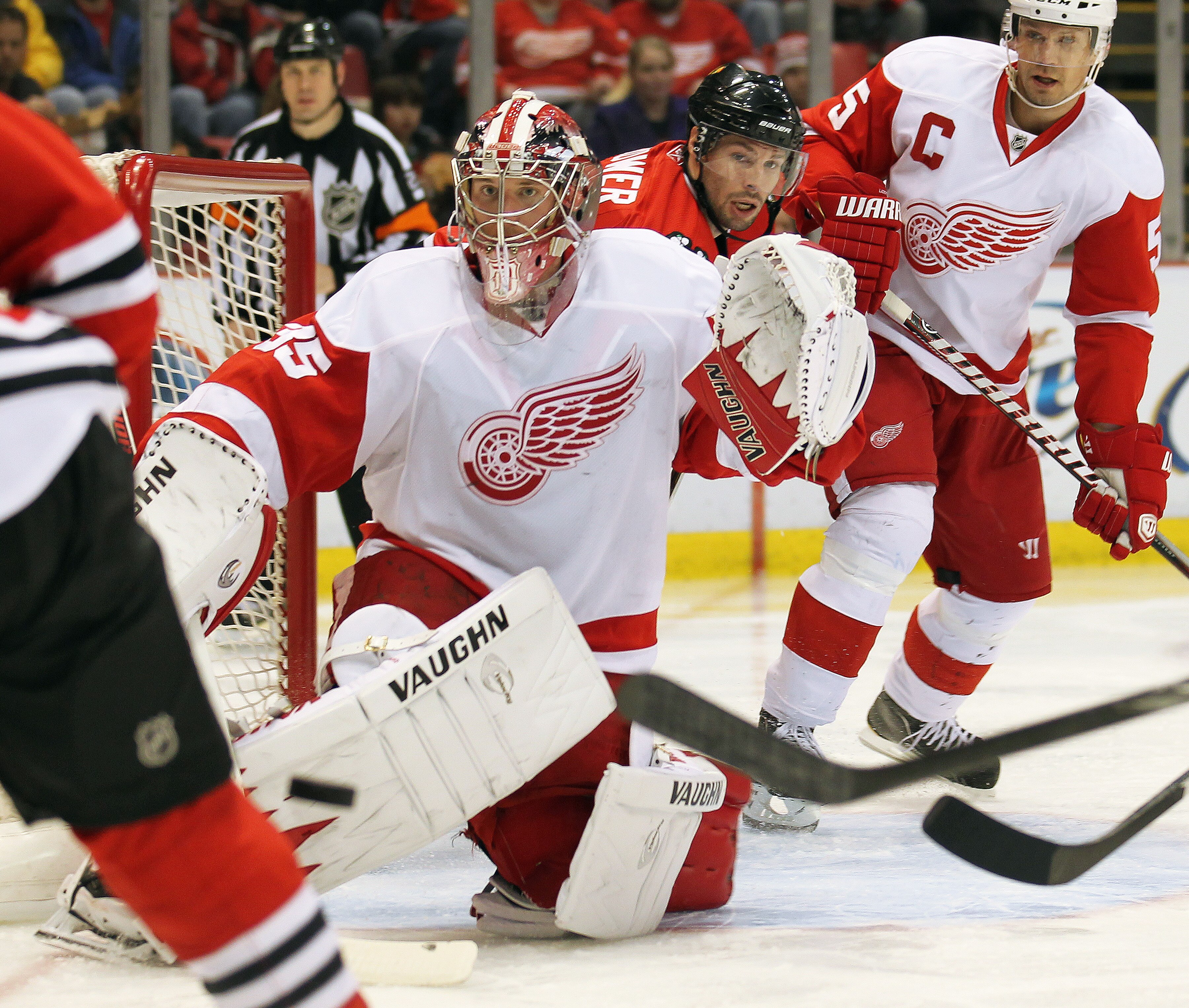 DETROIT, MI - JANUARY 22:  Jimmy Howard #35 of the Detroit Rewd Wings keeps an eye on an incoming puck in a game against the Chicago Black Hawks on January 22, 2011 at the Joe Louis Arena in Detroit, Michigan. The Hawks defeated the Wings 4-1. (Photo by C