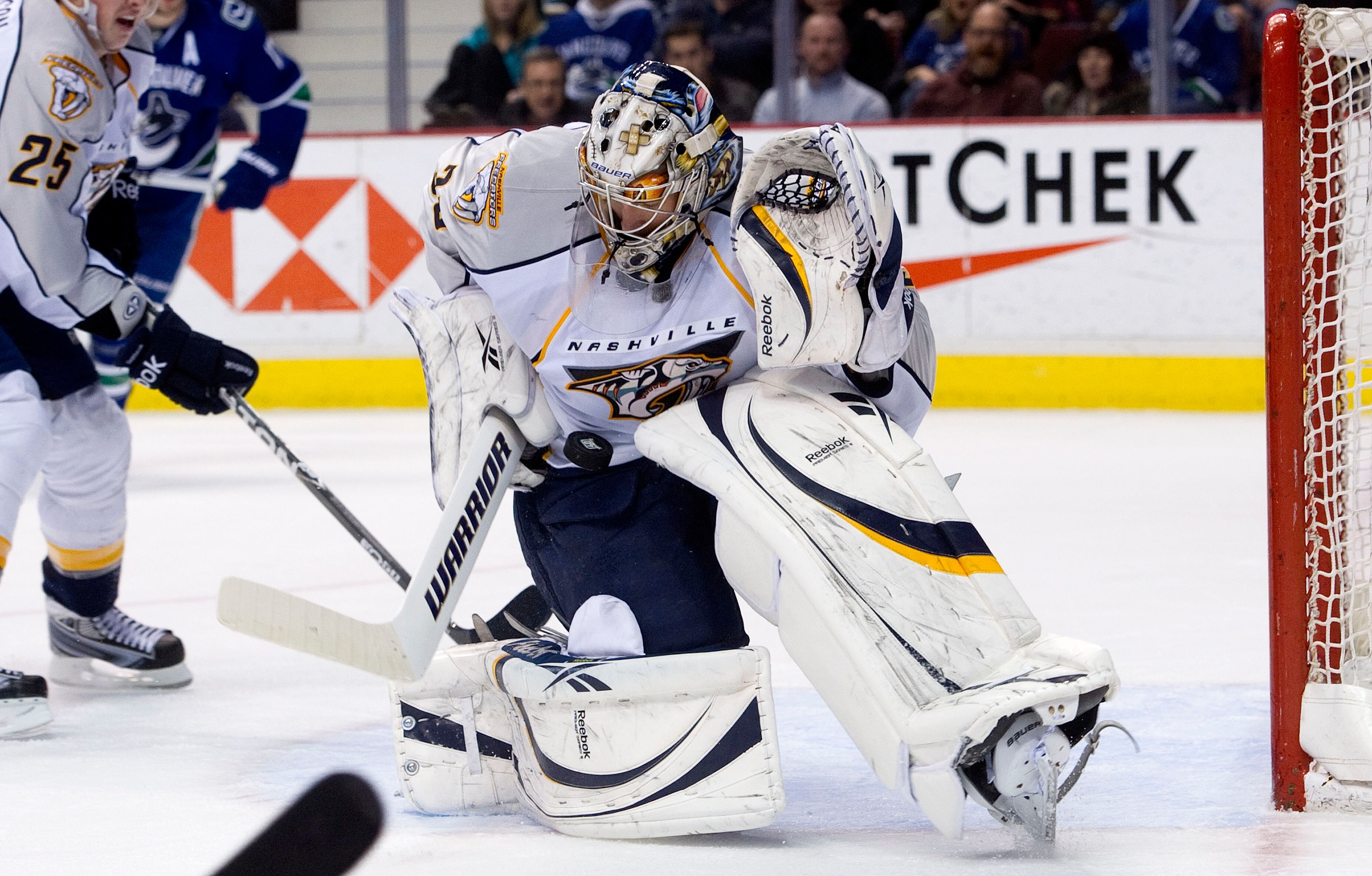 VANCOUVER, CANADA - JANUARY 26: Goalie Pekka Rinne #35 of the Nashville Predators slides across his crease to make a save against the Vancouver Canucks during the second period in NHL action on January 26, 2011 at Rogers Arena in Vancouver, British Columb