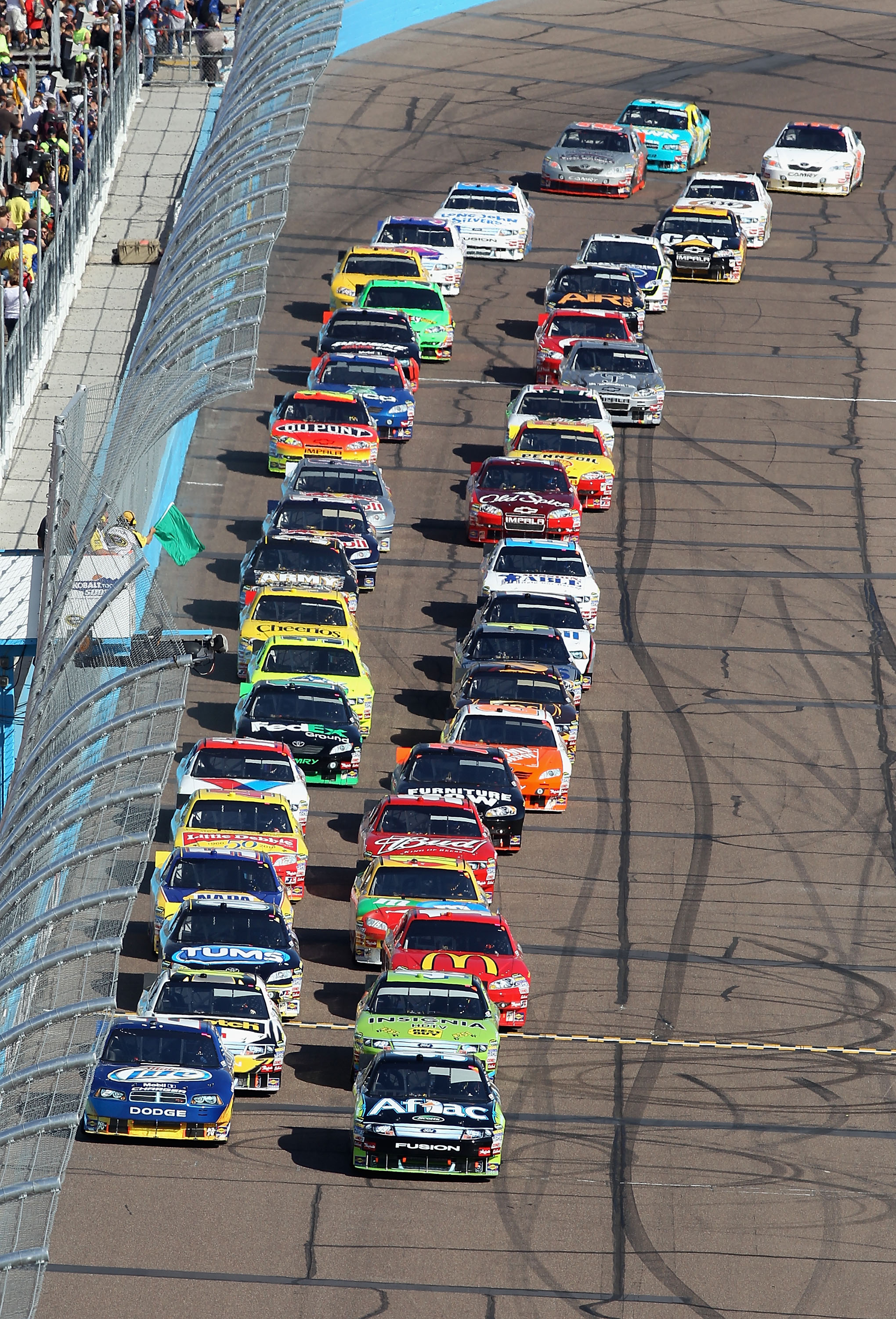 AVONDALE, AZ - NOVEMBER 14:  Carl Edwards, driver of the #99 Aflac Ford, leads the field at the start of the NASCAR Sprint Cup Series Kobalt Tools 500 at Phoenix International Raceway on November 14, 2010 in Avondale, Arizona. (Photo by Christian Petersen