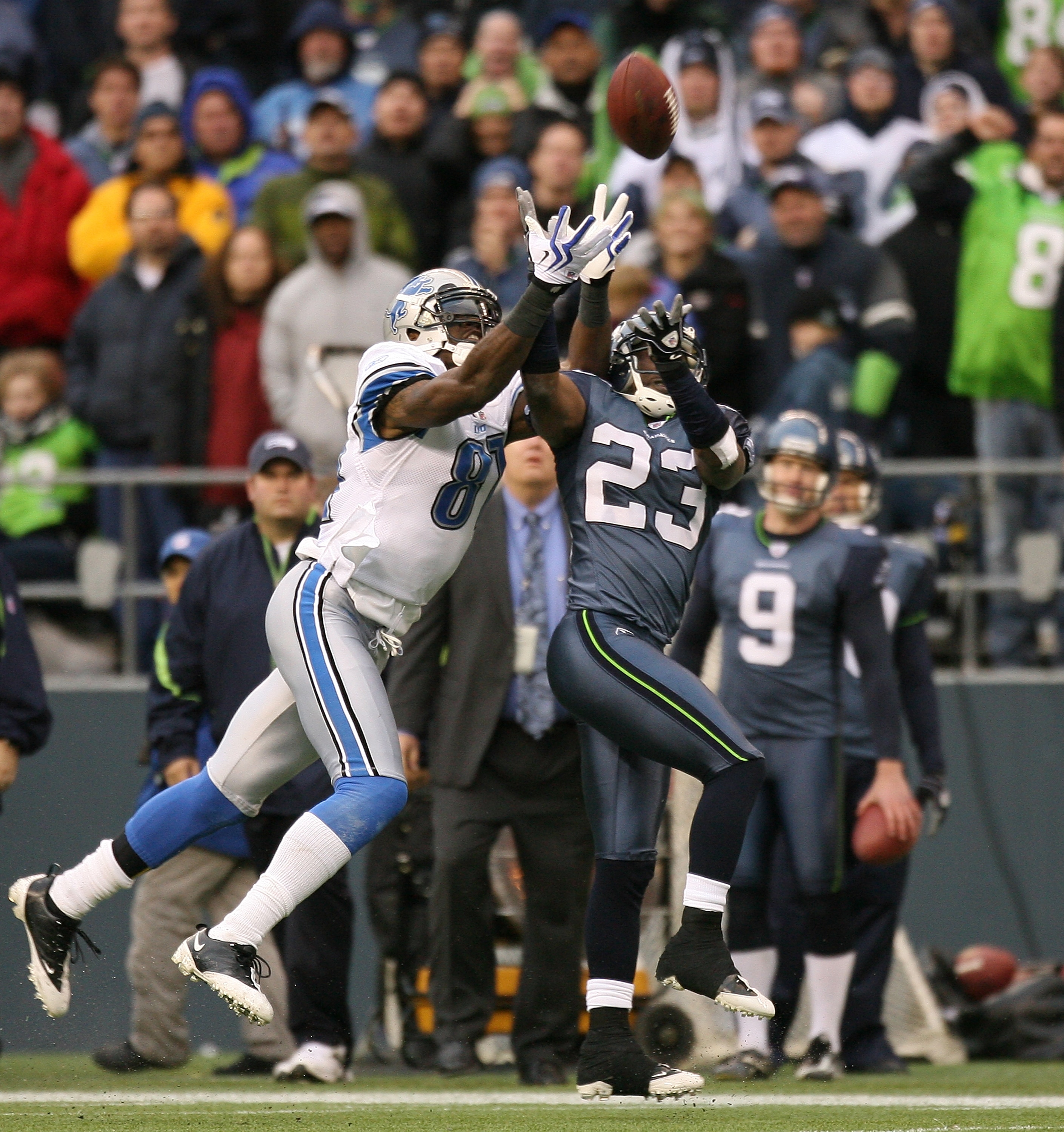 SEATTLE - NOVEMBER 08:  Cornerback Marcus Trufant #23 of the Seattle Seahawks makes an interception against Calvin Johnson #81 of the Detroit Lions on November 8, 2009 at Qwest Field in Seattle, Washington. The Seahawks defeated the Lions 32-20. (Photo by