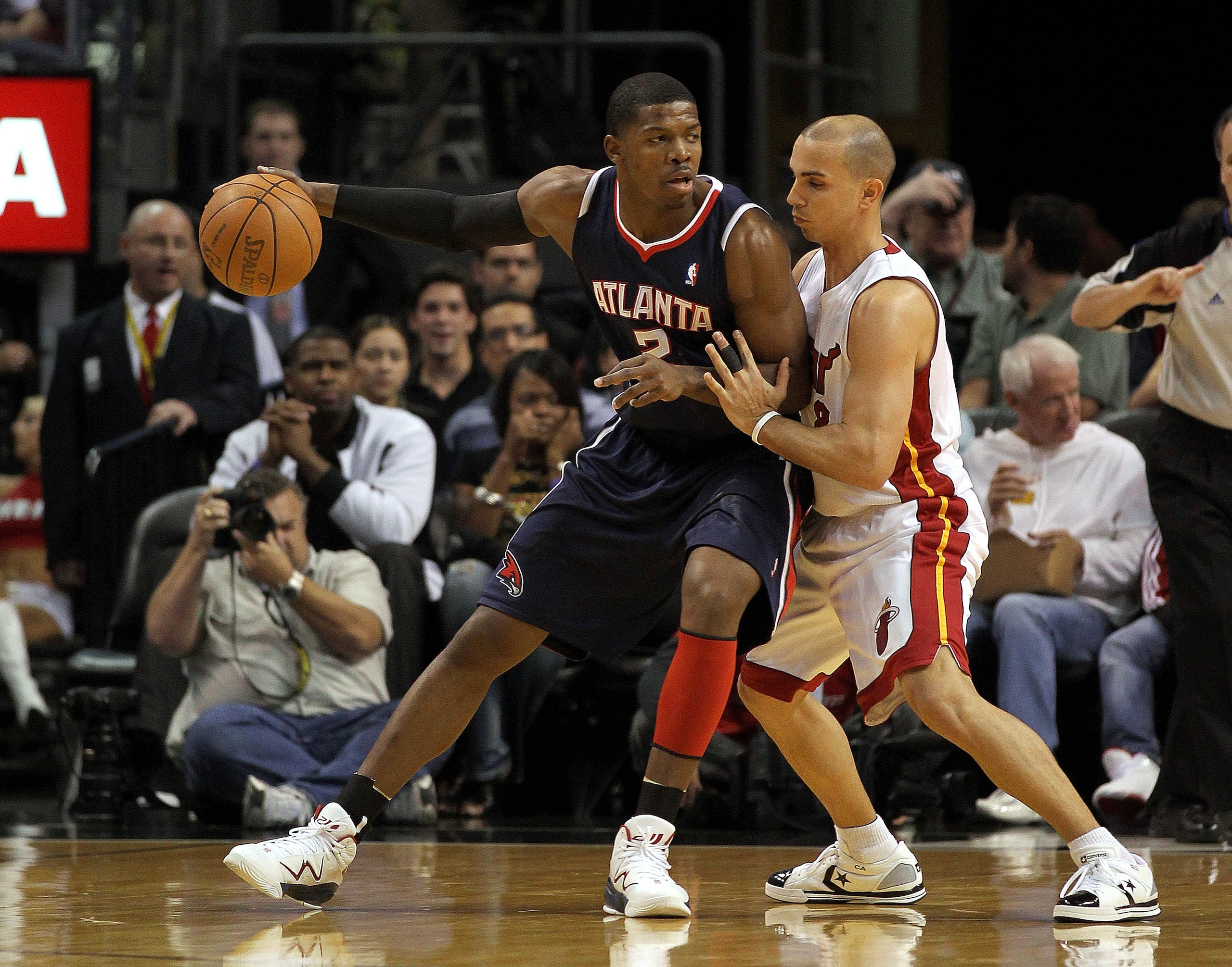 MIAMI, FL - JANUARY 18: Joe Johnson #2 of the Atlanta Hawks posts up against Carlos Arroyo #8 of the Miami Heat during a game at American Airlines Arena on January 18, 2011 in Miami, Florida. NOTE TO USER: User expressly acknowledges and agrees that, by MIAMI, FL - JANUARY 18: Joe Johnson #2 of the Atlanta Hawks posts up against Carlos Arroyo #8 of the Miami Heat during a game at American Airlines Arena on January 18, 2011 in Miami, Florida. NOTE TO USER: User expressly acknowledges and agrees that, by