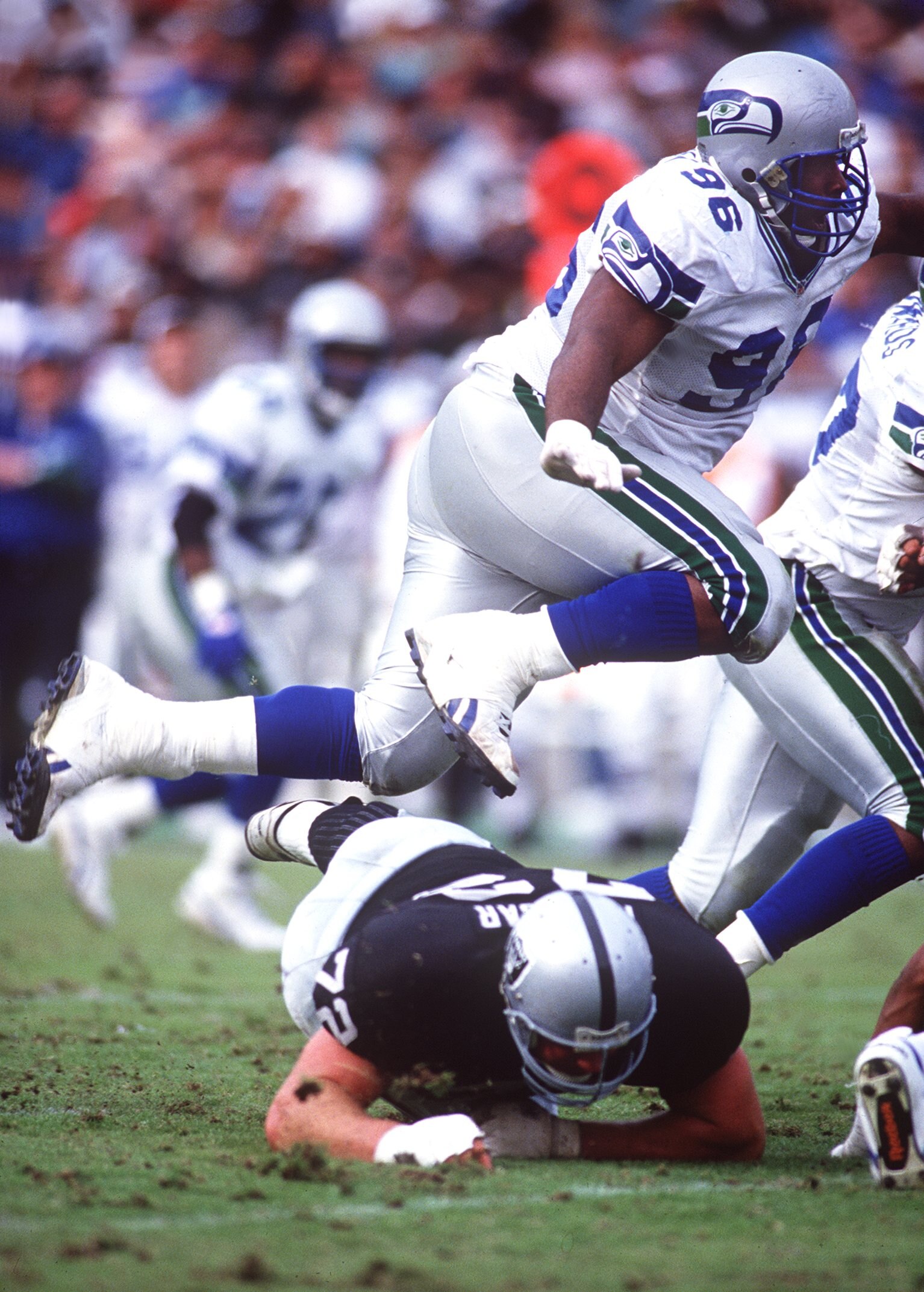 12 Dec 1993: SEATTLE DEFENSIVE TACKLE CORTEZ KENNEDY HURDLES LOS ANGLELES OFFENSIVE LINEMAN DON MOSEBAR DURING THE SEAHAWKS 27-23 LOSS TO THE RAIDERS AT THE LOS ANGELES MEMORIAL COLISEUM.