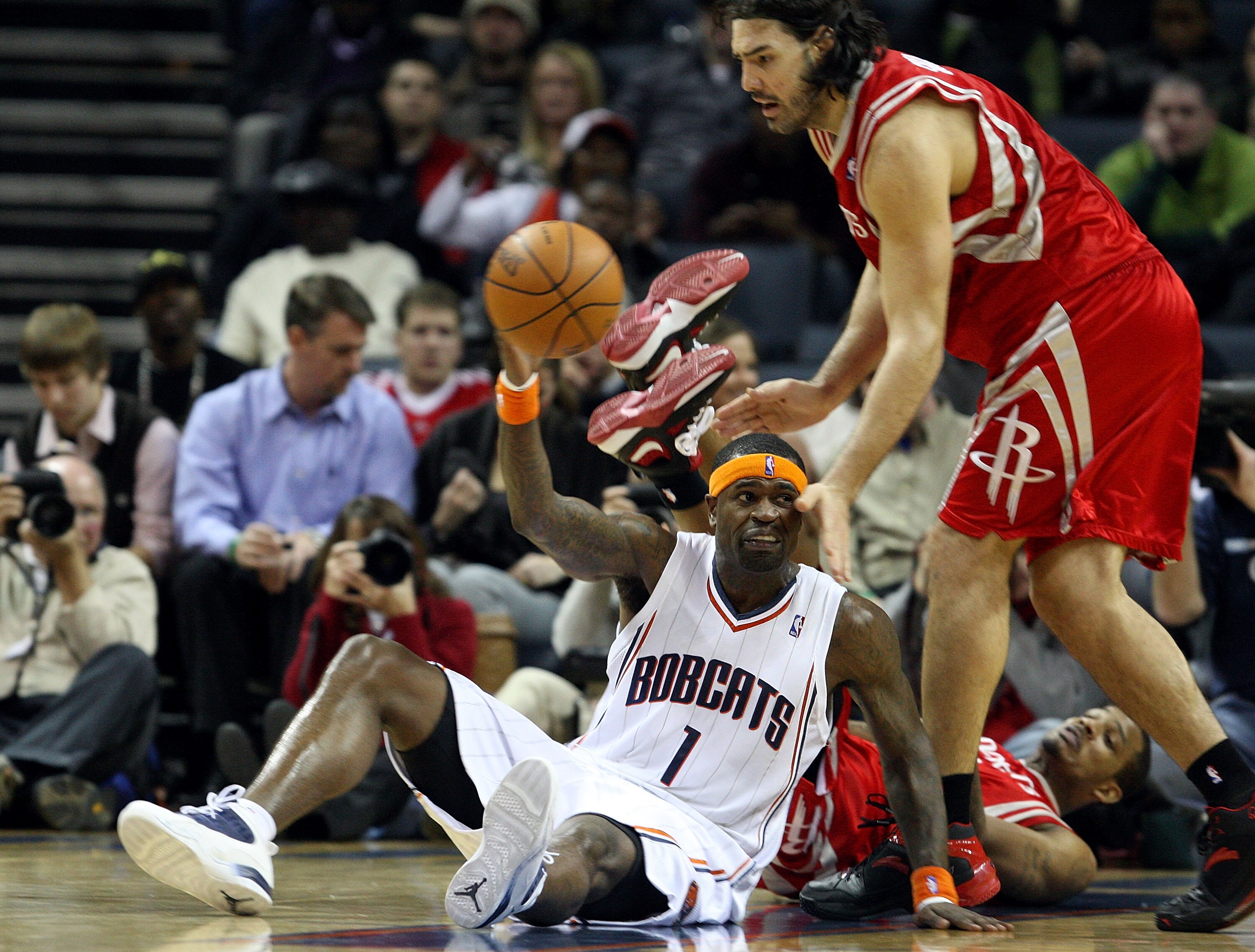 CHARLOTTE, NC - JANUARY 12:  Stephen Jackson #1 of the Charlotte Bobcats tries to keep the ball away from Luis Scola #4 of the Houston Rockets at Time Warner Cable Arena on January 12, 2010 in Charlotte, North Carolina.  NOTE TO USER: User expressly ackno