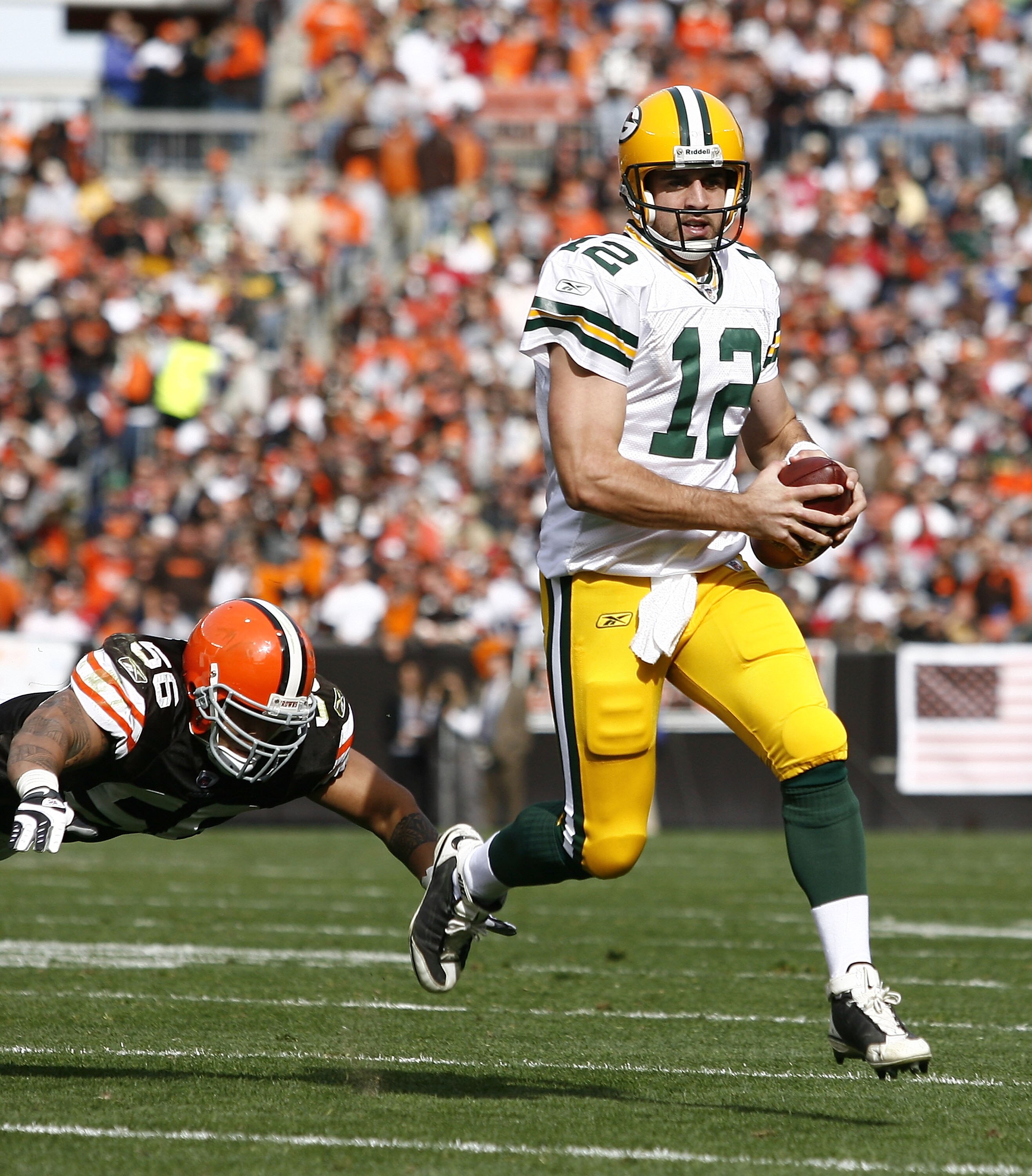CLEVELAND, OH - OCTOBER 25:  Aaron Rodgers #12 of the Green Bay Packers runs by Kaluka Maiava #56 of the Cleveland Browns at Cleveland Browns Stadium on October 25, 2009 in Cleveland, Ohio.  (Photo by Matt Sullivan/Getty Images)