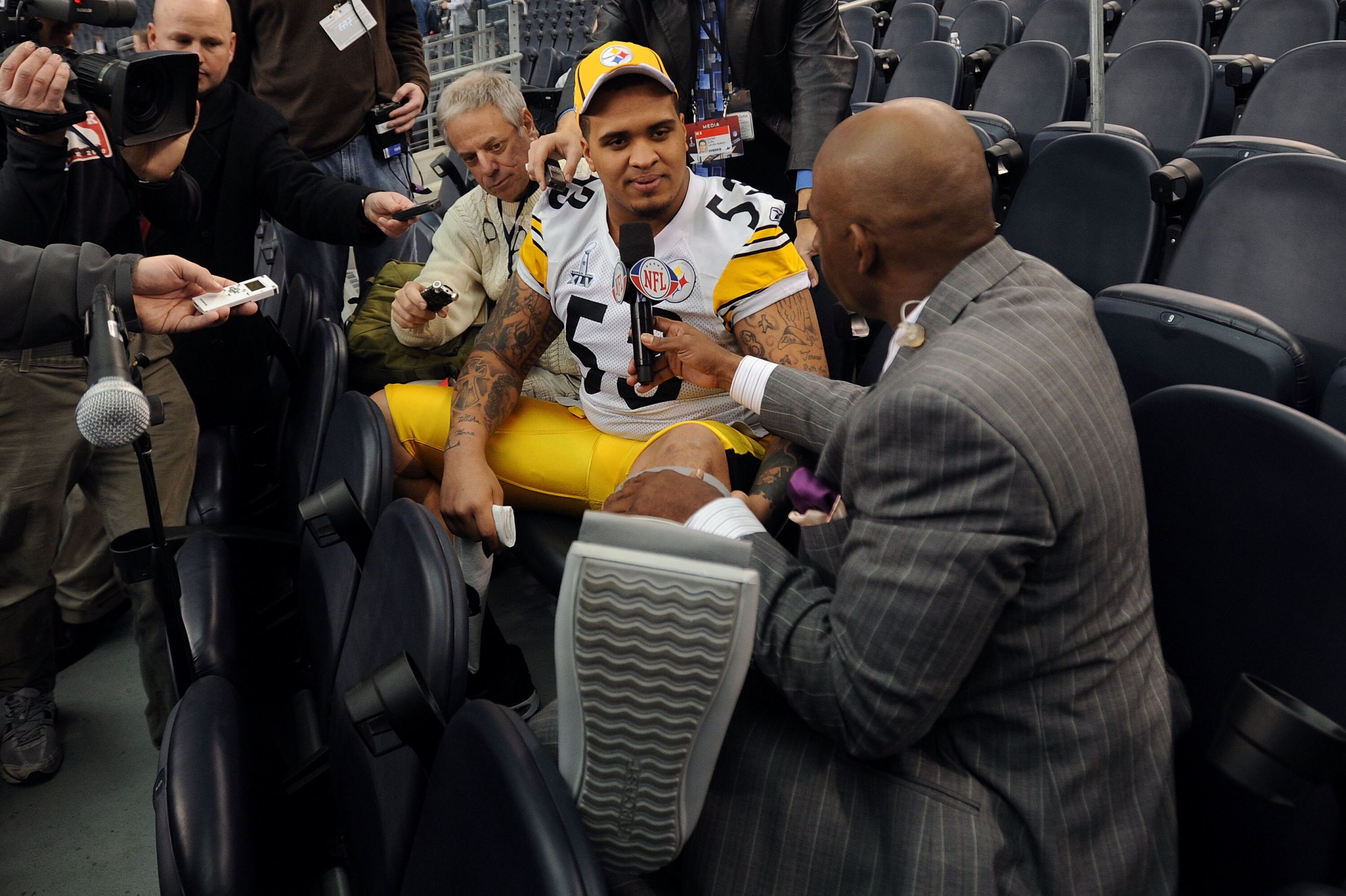 ARLINGTON, TX - FEBRUARY 01:  Maurkice Pouncey #53 of the Pittsburgh Steelers shows NFL Network's Deion Sanders his injured left ankle during Super Bowl XLV Media Day ahead of Super Bowl XLV at Cowboys Stadium on February 1, 2011 in Arlington, Texas. The 