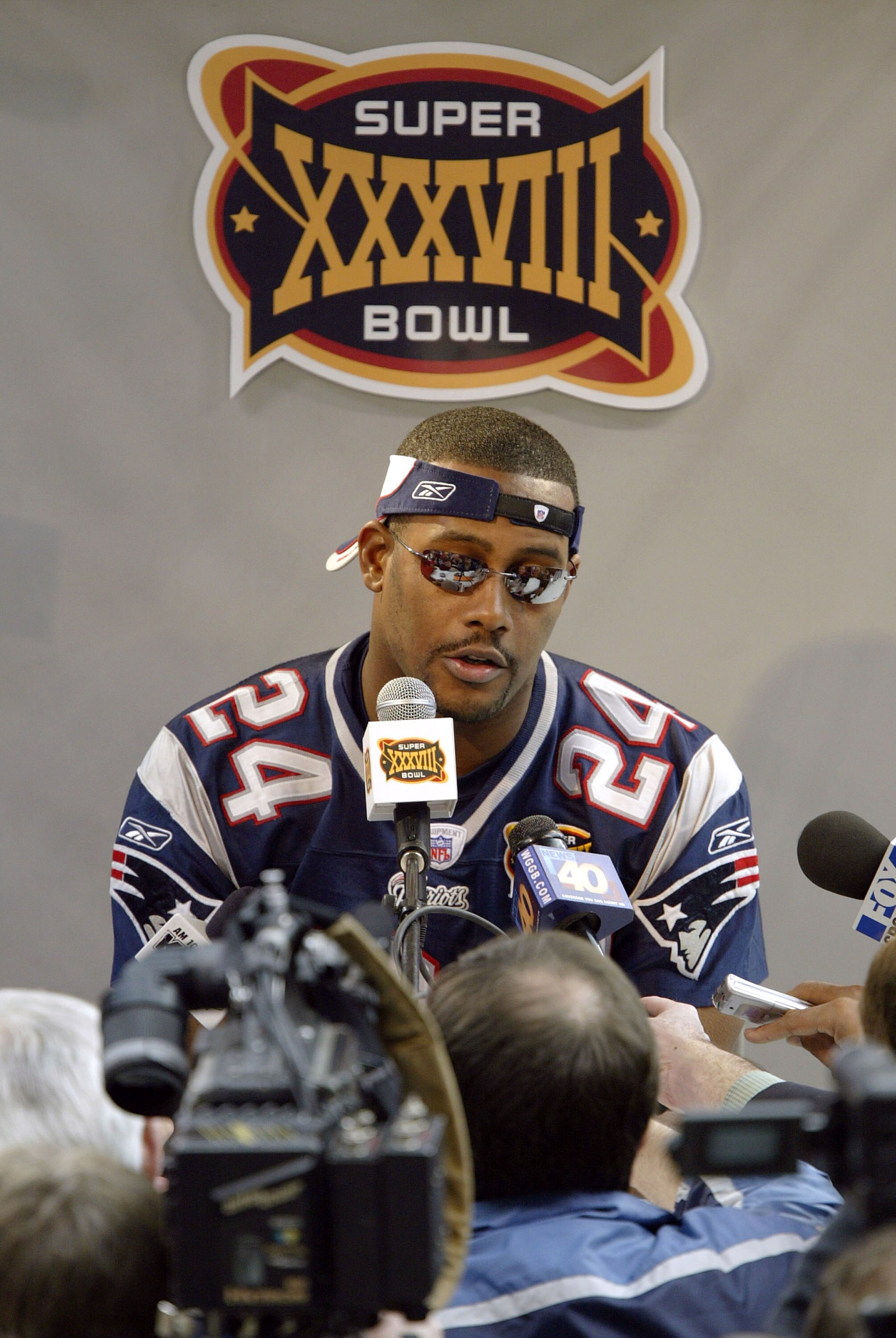 HOUSTON - JANUARY 27:  Cornerback Ty Law #24 of the New England Patriots answers questions on media day January 26, 2003 before Super Bowl XXXVIII against the Carolina Panthers in Houston, Texas.  (Photo by Brian Bahr/Getty Images)