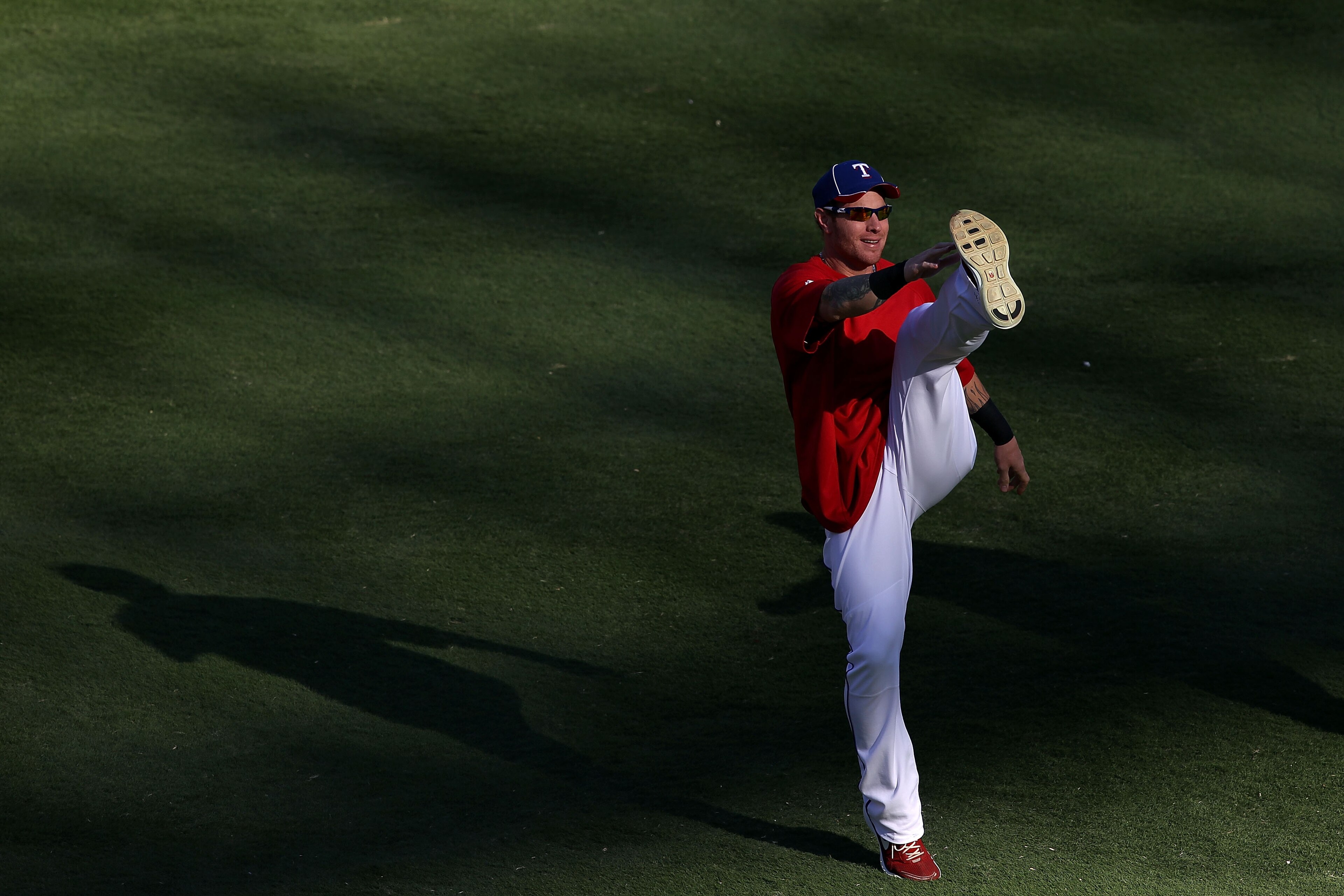 ARLINGTON, TX - NOVEMBER 01:  Josh Hamilton #32 of the Texas Rangers stretches in the outfield against of the San Francisco Giants in Game Five of the 2010 MLB World Series at Rangers Ballpark in Arlington on November 1, 2010 in Arlington, Texas.  (Photo