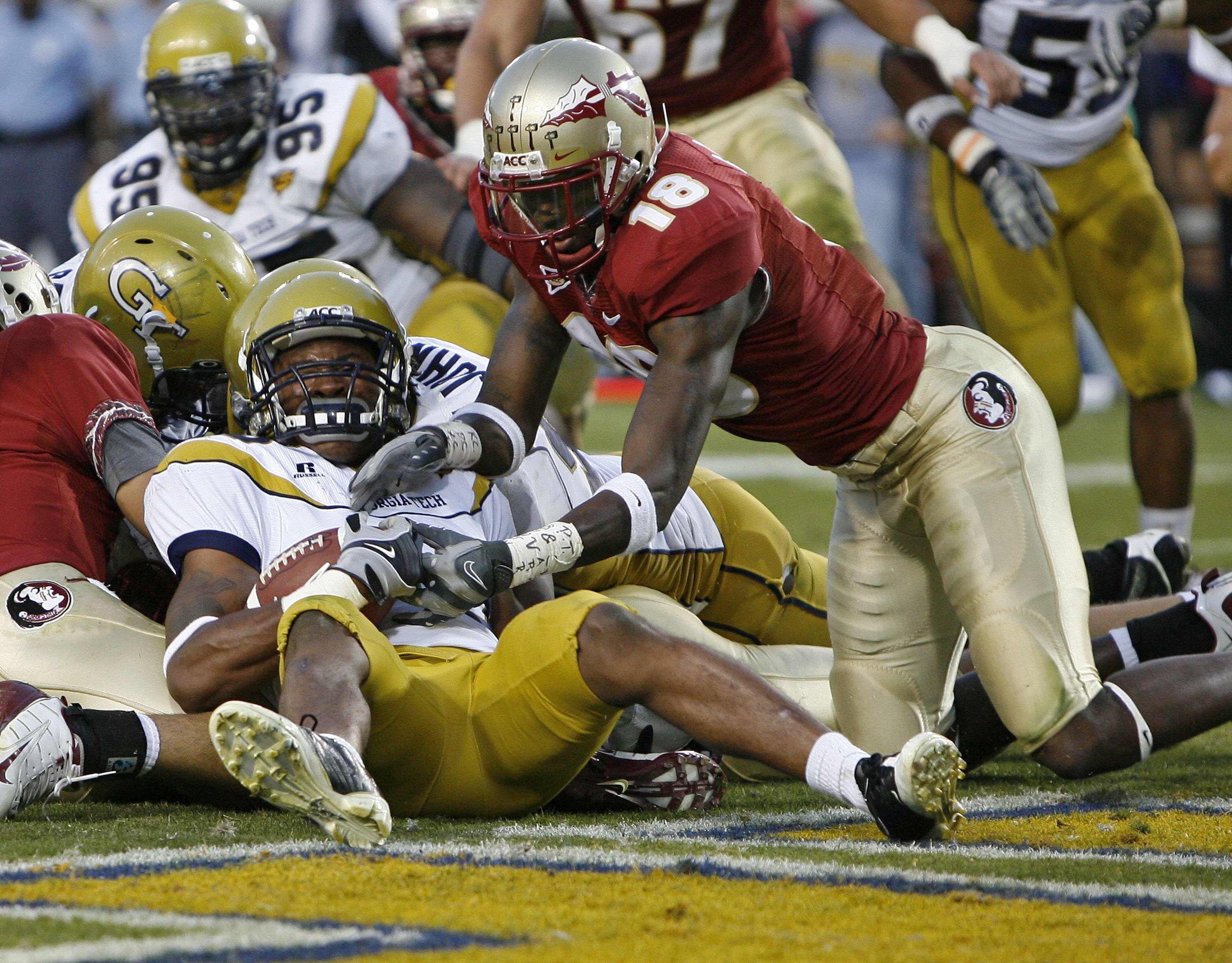 ATLANTA - NOVEMBER 1:  Cornerback Rashaad Reid #28 of the Georgia Tech Yellow Jackets recovers a fumble in the end zone in the fourth quarter to seal the win as wide receiver Greg Carr #18 of the Florida State Seminoles tackles him during the game at Bobb