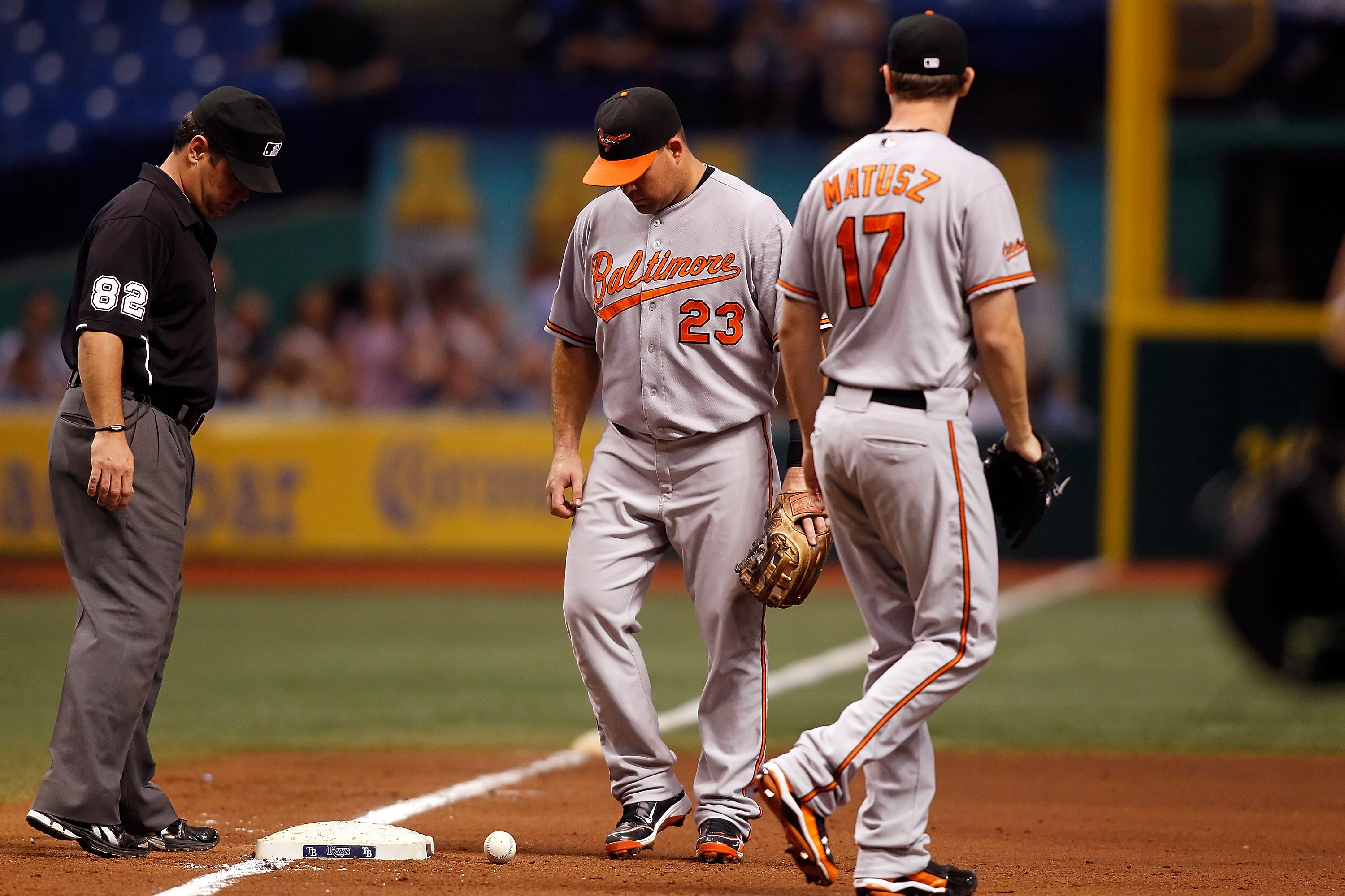 ST. PETERSBURG - SEPTEMBER 27:  Ty Wigginton #23 of the Baltimore Orioles watches a bunt in hopes that it would roll foul with pitcher Brian Matusz #17 looking on against the Tampa Bay Rays during the game at Tropicana Field on September 27, 2010 in St. P