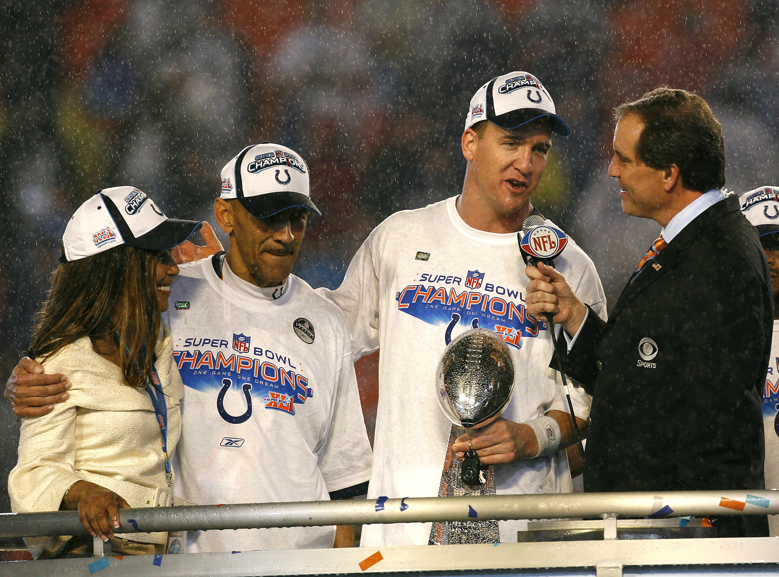 Peyton Manning of the Indianapolis Colts, flanked by head coach Tony Dungy, is interviewed after winning the Indianapolis Colts and the Chicago Bears match-up in Super Bowl XLI in Miami, Florida on February 4, 2007. (Photo by Kevin C.  Cox/Getty Images)