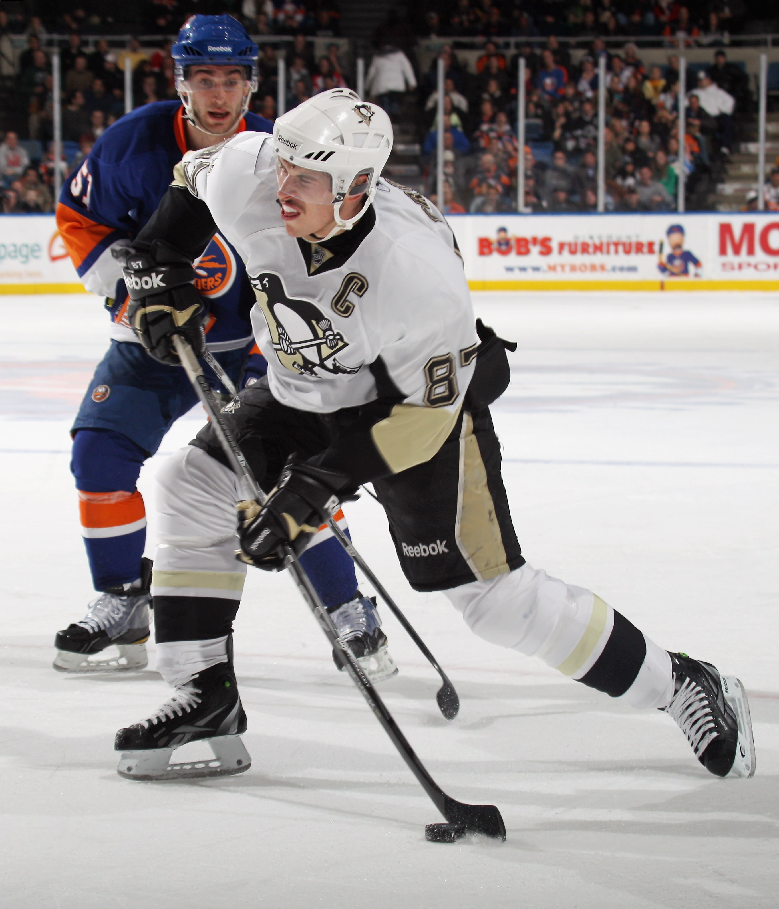 UNIONDALE, NY - DECEMBER 29: Sidney Crosby #87 of the Pittsburgh Penguins takes the shot against the New York Islanders at the Nassau Coliseum on December 29, 2010 in Uniondale, New York.  (Photo by Bruce Bennett/Getty Images)