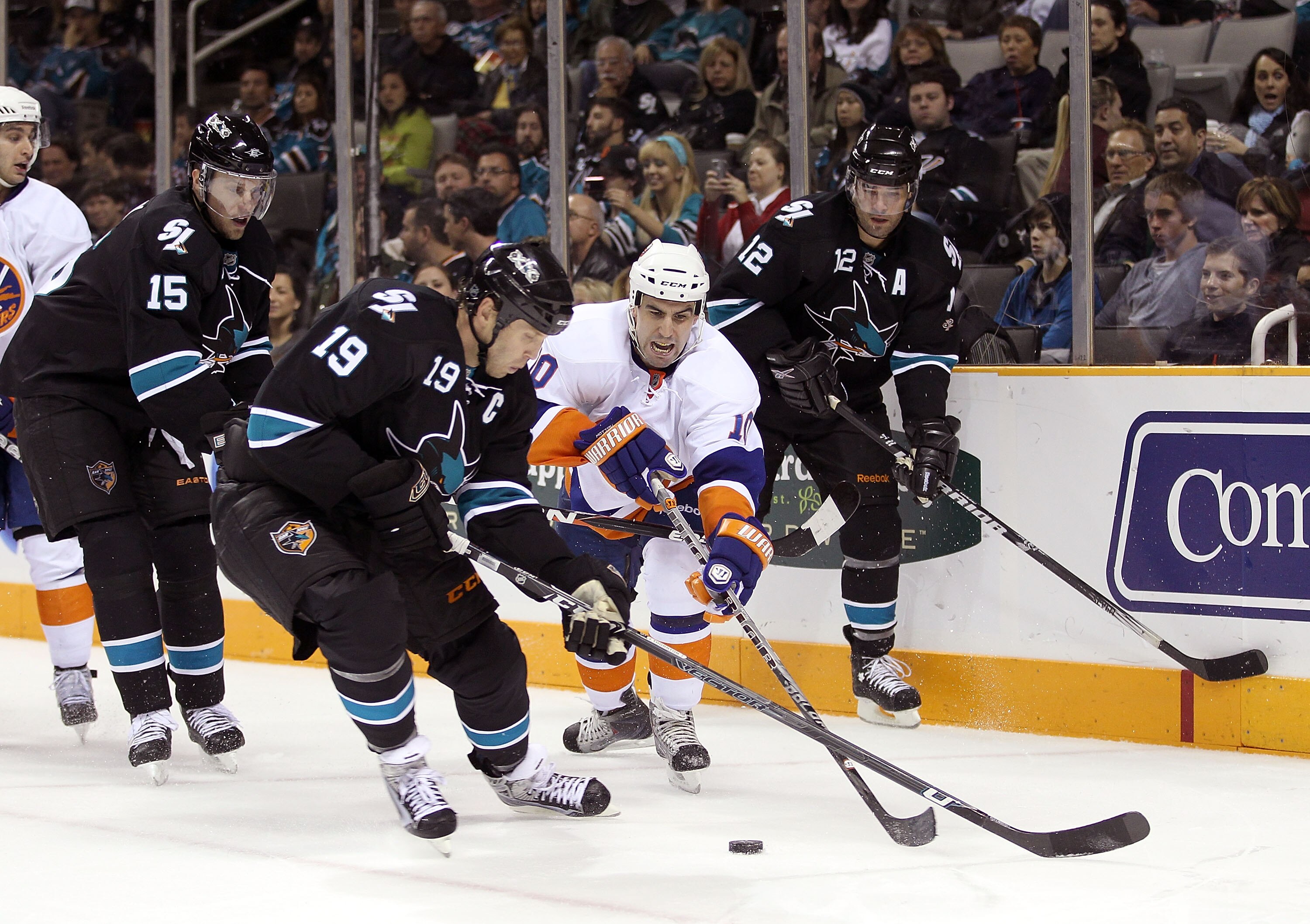 SAN JOSE, CA - NOVEMBER 11:  Matt Mottau #10 of the New York Islanders is surrounded by Joe Thornton #19, Dany Heatley #15 and Patrick Marleau #12 of the San Jose Sharks on November 11, 2010 in San Jose, California.  (Photo by Ezra Shaw/Getty Images)