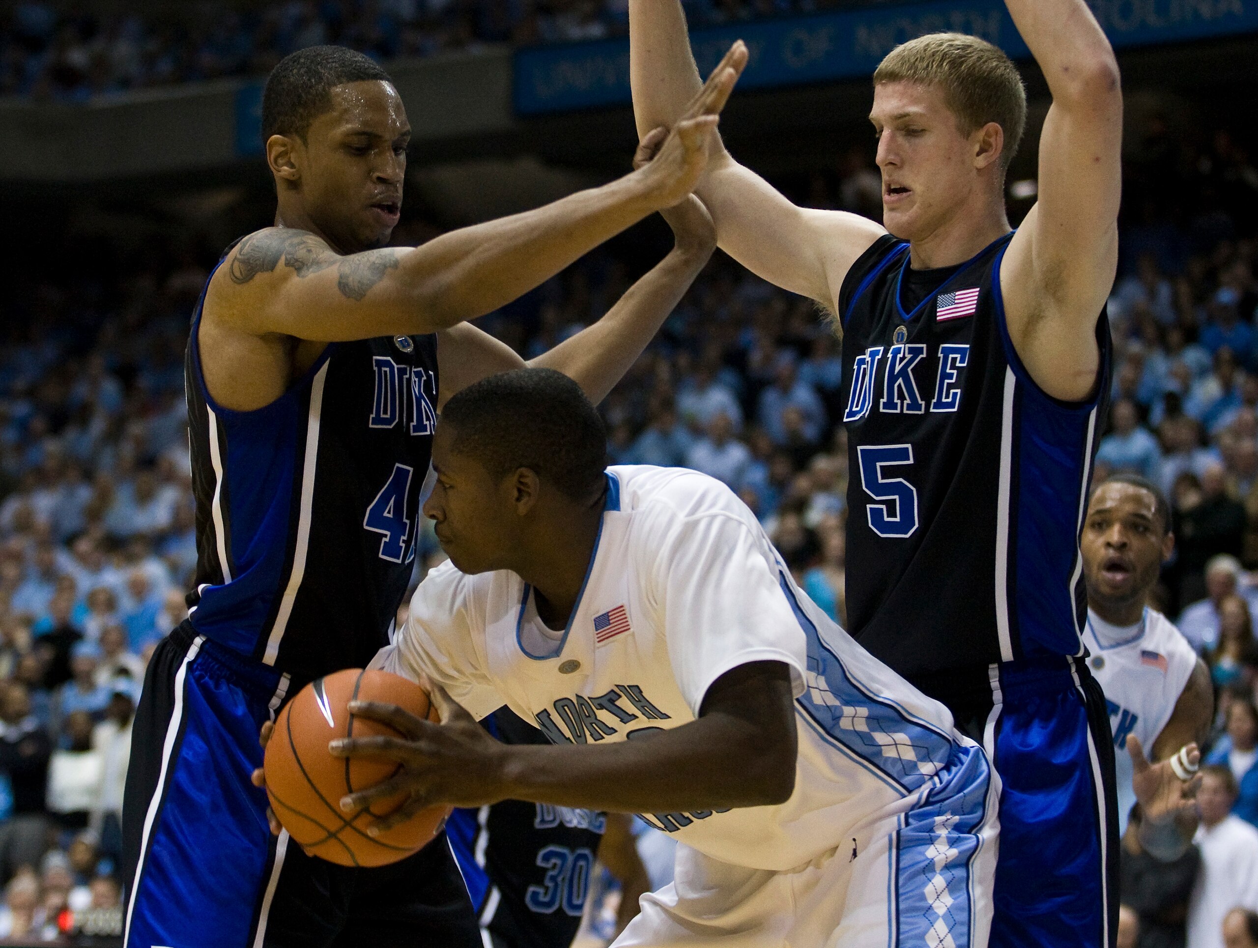 CHAPEL HILL, NC - FEBRUARY 10: North Carolina forward Ed Davis #32 looks to pass around Duke forward Lance Thomas (42) and Duke forward Mason Plumlee (5) during a men's college basketball game at Dean Smith Center on February 10, 2010 in Chapel Hill, Nort CHAPEL HILL, NC - FEBRUARY 10: North Carolina forward Ed Davis #32 looks to pass around Duke forward Lance Thomas (42) and Duke forward Mason Plumlee (5) during a men's college basketball game at Dean Smith Center on February 10, 2010 in Chapel Hill, Nort