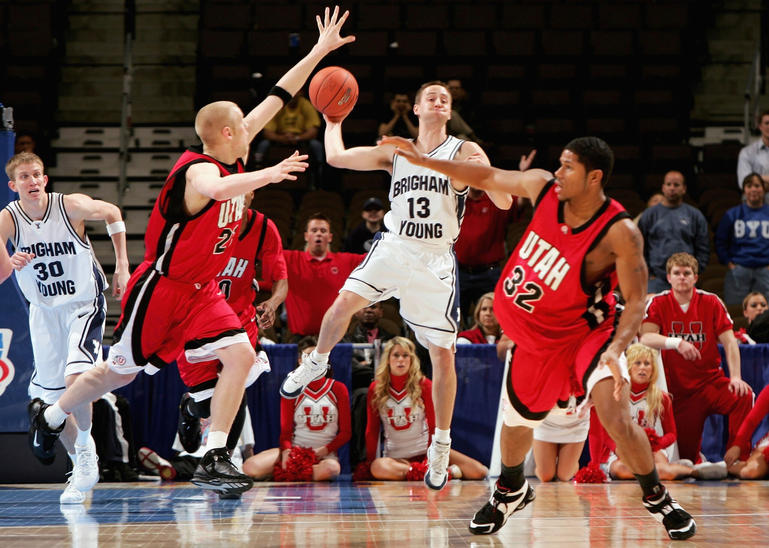 DENVER - MARCH 09: Austin Ainge #13 of the Brigham Young University Cougars unloads a pass to a teammate over Ricky Johns #32 as Shaun Green #21 of the Utah Runnin' Utes defends as the Utes upset the Cougars 74-70 during the Mountain West Conference Bask DENVER - MARCH 09: Austin Ainge #13 of the Brigham Young University Cougars unloads a pass to a teammate over Ricky Johns #32 as Shaun Green #21 of the Utah Runnin' Utes defends as the Utes upset the Cougars 74-70 during the Mountain West Conference Bask