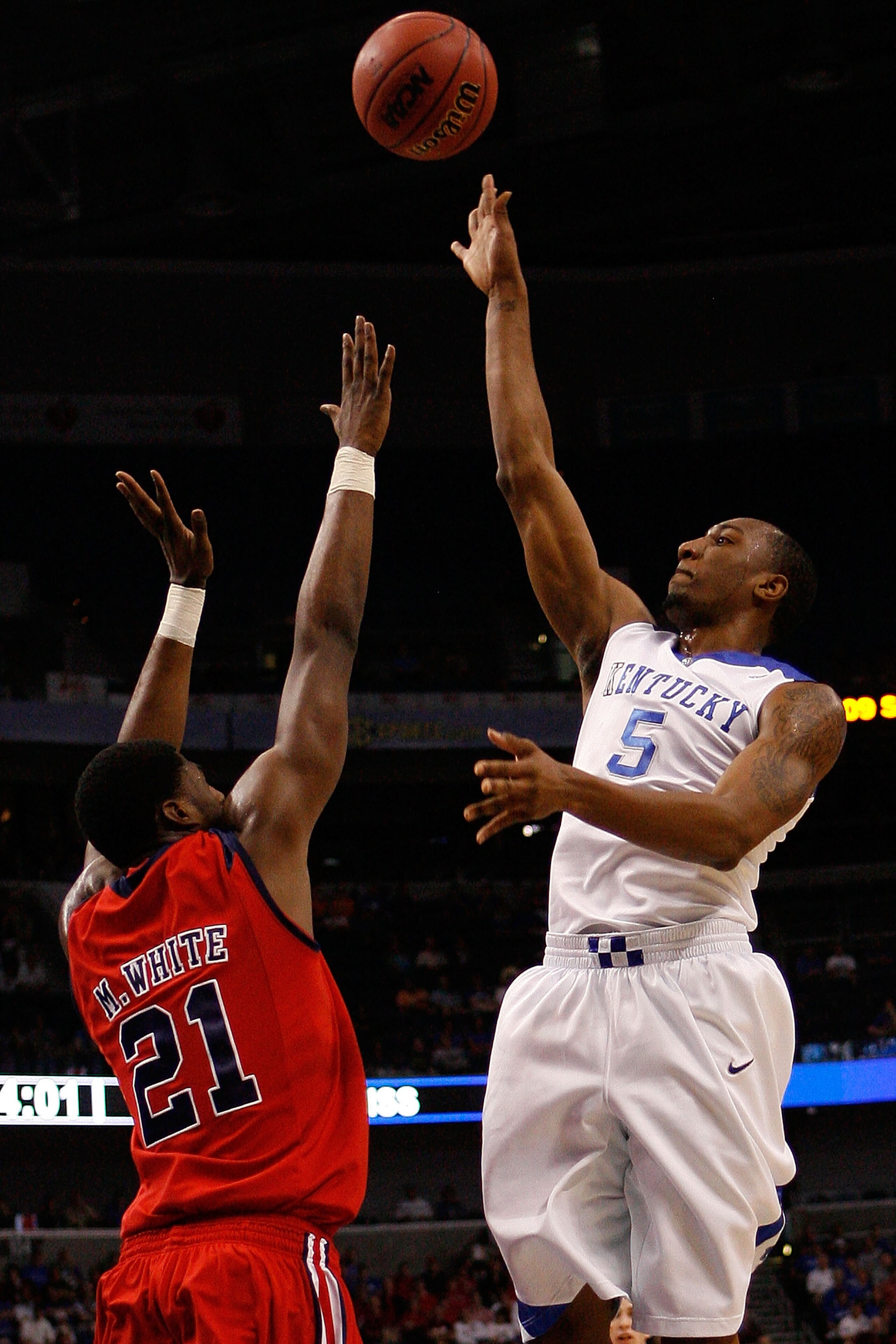 TAMPA, FL - MARCH 12: Ramon Harris #5 of the Kentucky Wildcats makes a shot over Malcom White #21 of The Ole Miss Rebels during the first round of the SEC Men's Basketball Tournament on March 12, 2009 at The St. Pete Times Forum in Tampa, Florida. (Phot TAMPA, FL - MARCH 12: Ramon Harris #5 of the Kentucky Wildcats makes a shot over Malcom White #21 of The Ole Miss Rebels during the first round of the SEC Men's Basketball Tournament on March 12, 2009 at The St. Pete Times Forum in Tampa, Florida. (Phot