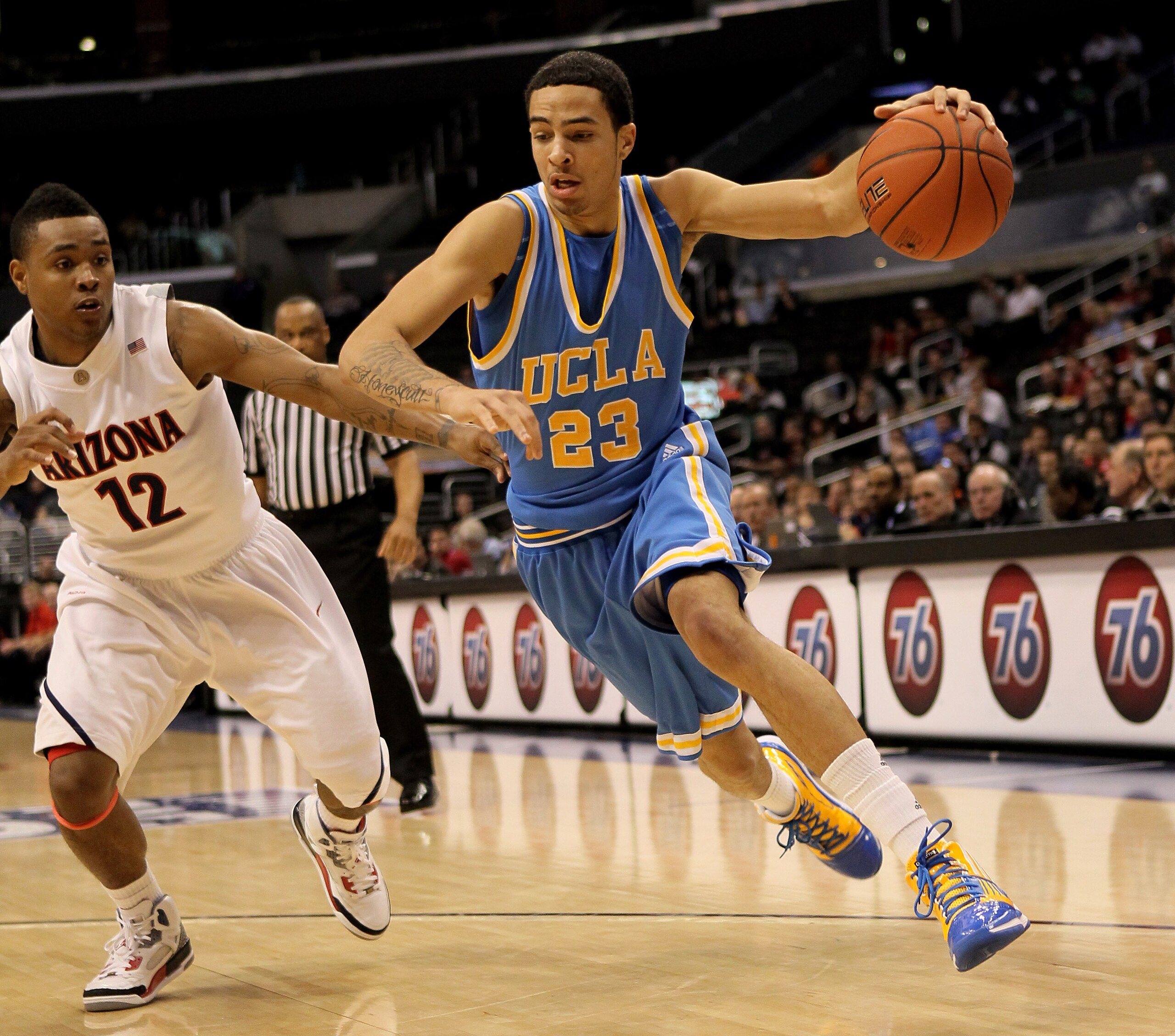 LOS ANGELES, CA - MARCH 11: Tyler Honeycutt #23 of the UCLA Bruins drives around Lamont Jones #12 of the Arizona Wildcats during the quarterfinals of the Pac-10 Basketball Tournament at Staples Center on March 11, 2010 in Los Angeles, California. UCLA wo LOS ANGELES, CA - MARCH 11: Tyler Honeycutt #23 of the UCLA Bruins drives around Lamont Jones #12 of the Arizona Wildcats during the quarterfinals of the Pac-10 Basketball Tournament at Staples Center on March 11, 2010 in Los Angeles, California. UCLA wo