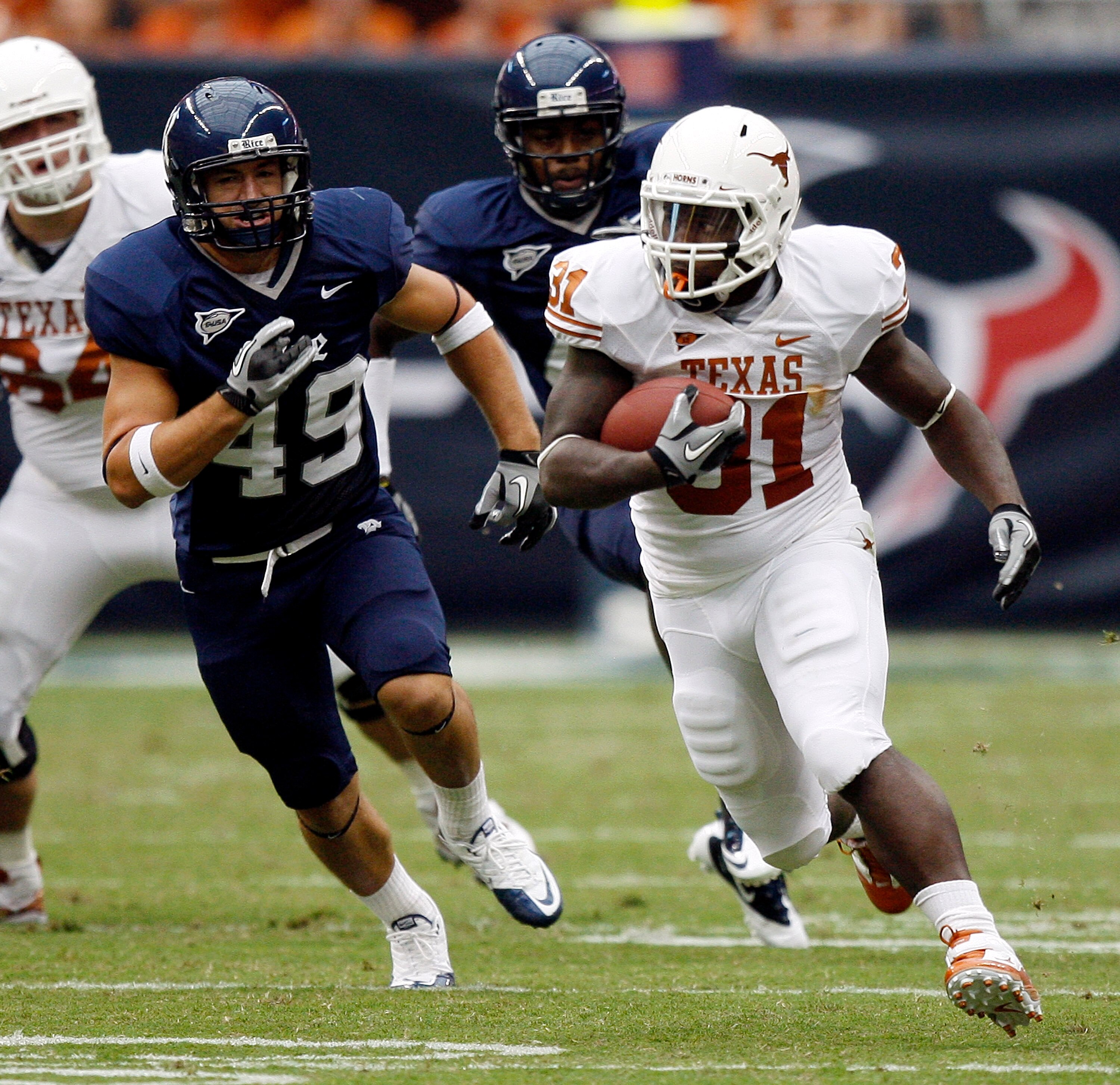 HOUSTON - SEPTEMBER 04: Running back Cody Johnson #31 of the Texas Longhorns rushes past linebacker Trey Briggs #49 of the Rice Owls in the second quarter at Reliant Stadium on September 4, 2010 in Houston, Texas. (Photo by Bob Levey/Getty Images) HOUSTON - SEPTEMBER 04: Running back Cody Johnson #31 of the Texas Longhorns rushes past linebacker Trey Briggs #49 of the Rice Owls in the second quarter at Reliant Stadium on September 4, 2010 in Houston, Texas. (Photo by Bob Levey/Getty Images)