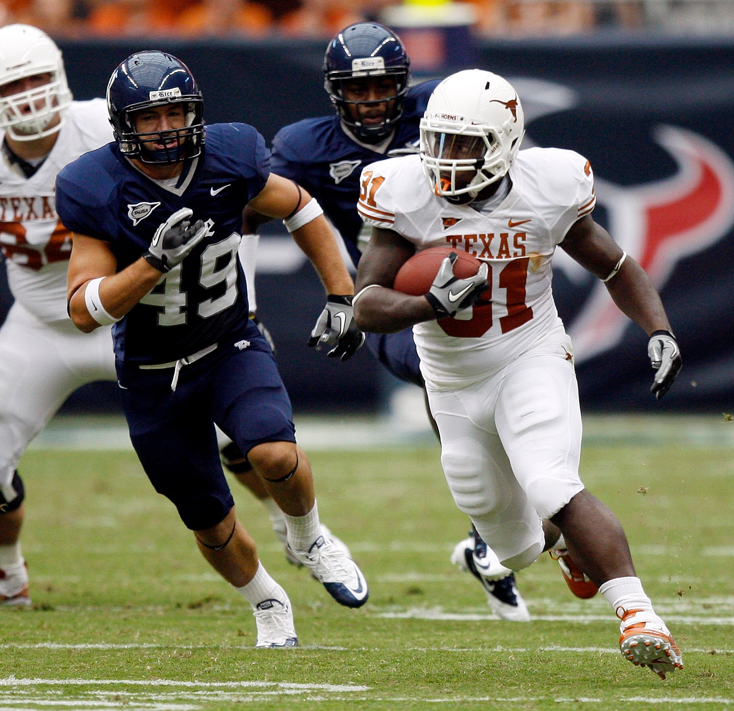 HOUSTON - SEPTEMBER 04: Running back Cody Johnson #31 of the Texas Longhorns rushes past linebacker Trey Briggs #49 of the Rice Owls in the second quarter at Reliant Stadium on September 4, 2010 in Houston, Texas. (Photo by Bob Levey/Getty Images) HOUSTON - SEPTEMBER 04: Running back Cody Johnson #31 of the Texas Longhorns rushes past linebacker Trey Briggs #49 of the Rice Owls in the second quarter at Reliant Stadium on September 4, 2010 in Houston, Texas. (Photo by Bob Levey/Getty Images)