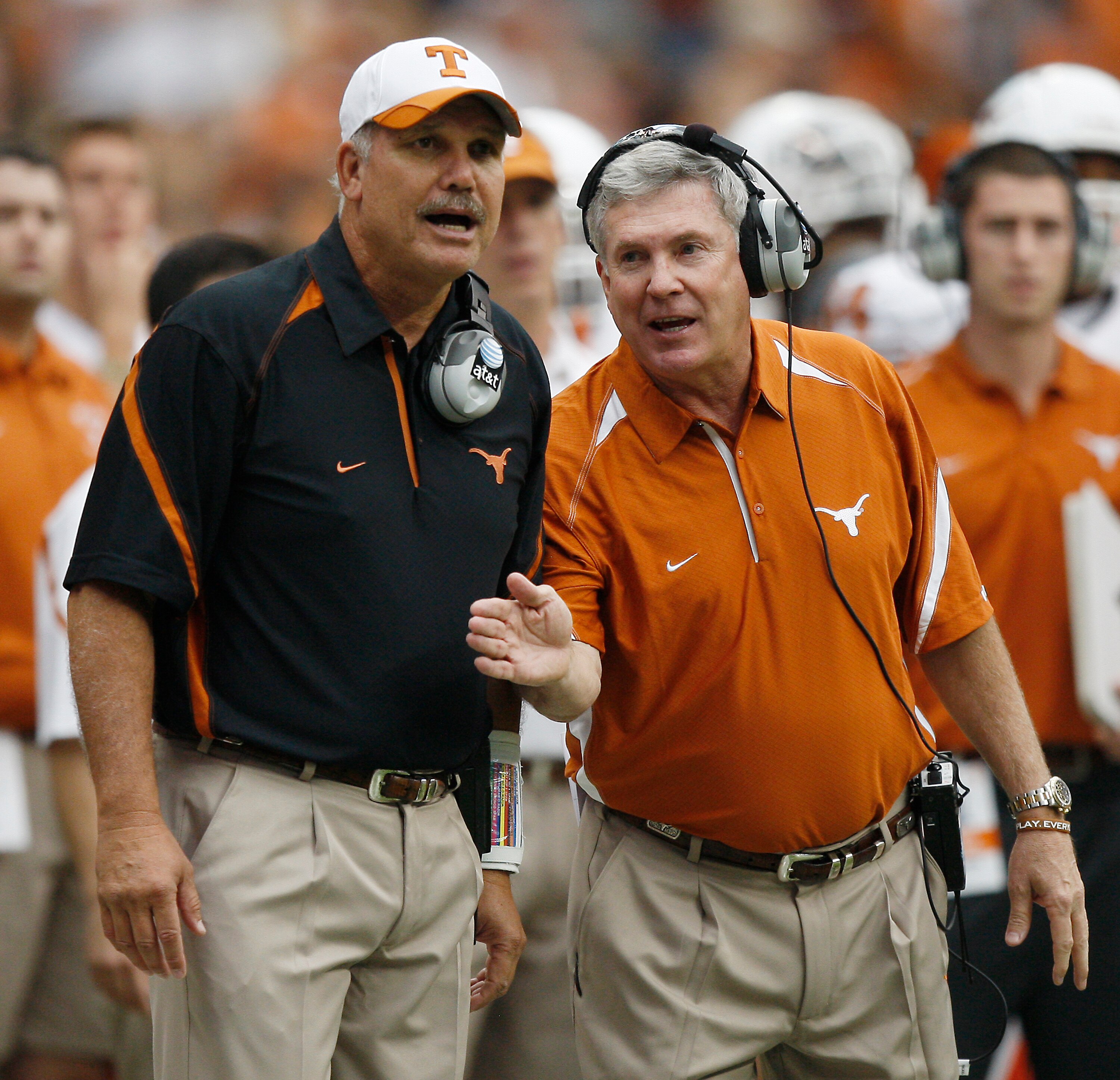 HOUSTON - SEPTEMBER 04: Head coach Mack Brown, right, and assistant head coach Duane Akina chat on the sidelines during a game against the Rice Owls at Reliant Stadium on September 4, 2010 in Houston, Texas. (Photo by Bob Levey/Getty Images) HOUSTON - SEPTEMBER 04: Head coach Mack Brown, right, and assistant head coach Duane Akina chat on the sidelines during a game against the Rice Owls at Reliant Stadium on September 4, 2010 in Houston, Texas. (Photo by Bob Levey/Getty Images)