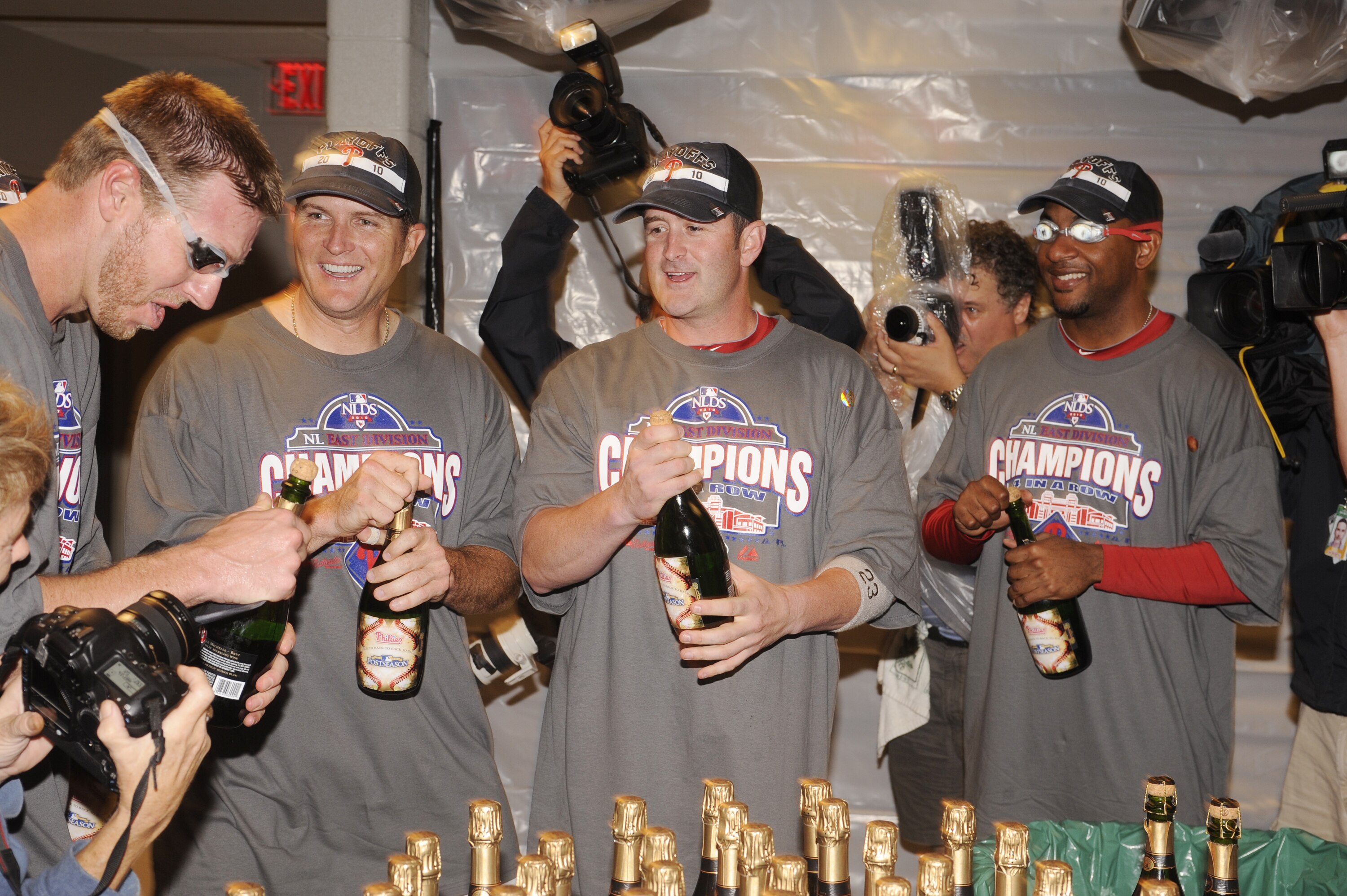 WASHINGTON - SEPTEMBER 27:  Roy Halliday, Mike Sweeney, Brian Schneider and Ben Francisco of the Philadelphia Phillies celebrate clinching the National League east title after a baseball game against the Washington Nationals on September 27, 2010 at Natio
