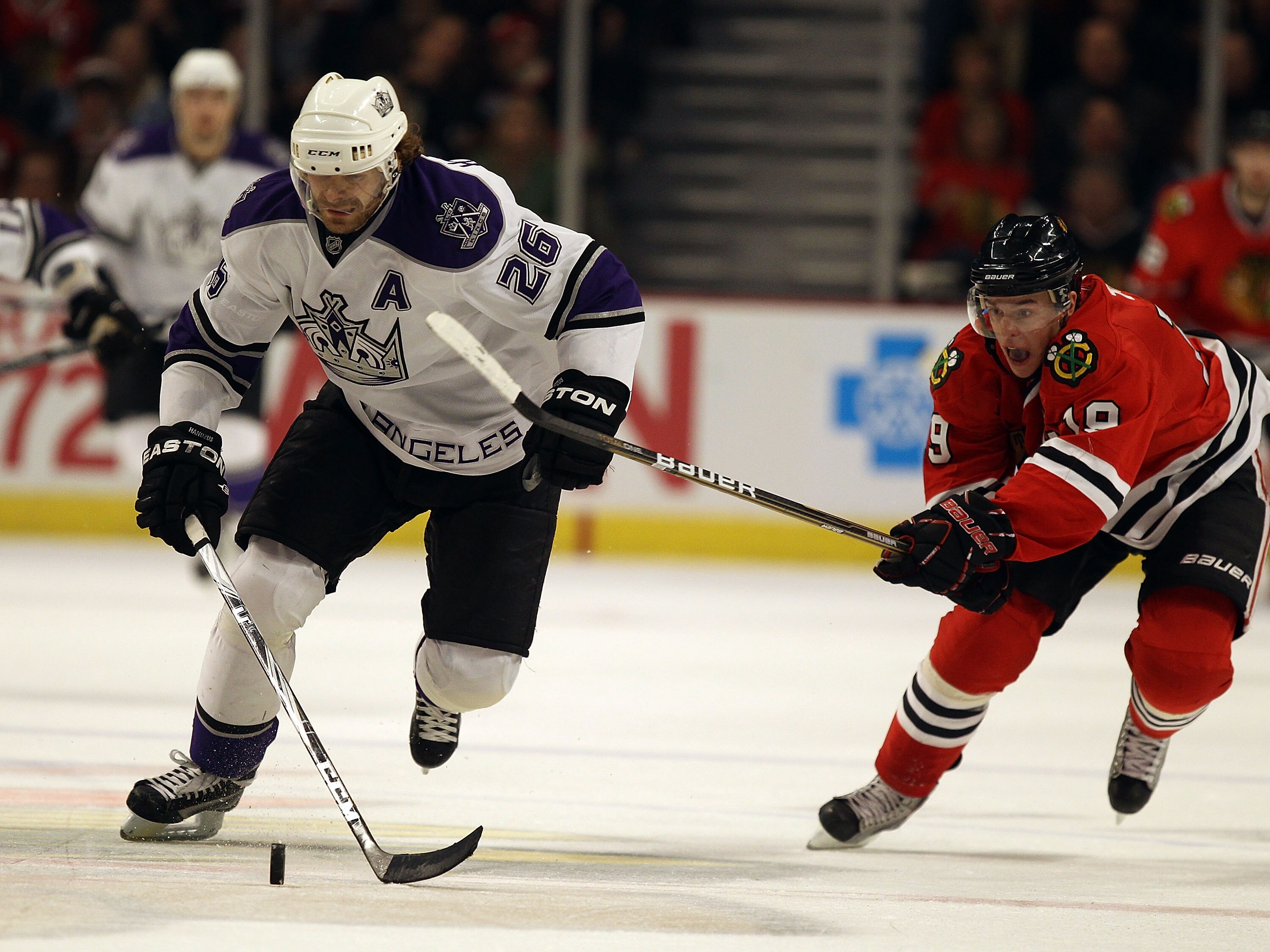 CHICAGO, IL - DECEMBER 19: Michal Handzus #26 of the Los Angeles Kings skates up the ice under pressure from Jonathan Toews #19 of the Chicago Blackhawks at the United Center on December 19, 2010 in Chicago, Illinois. (Photo by Jonathan Daniel/Getty Image