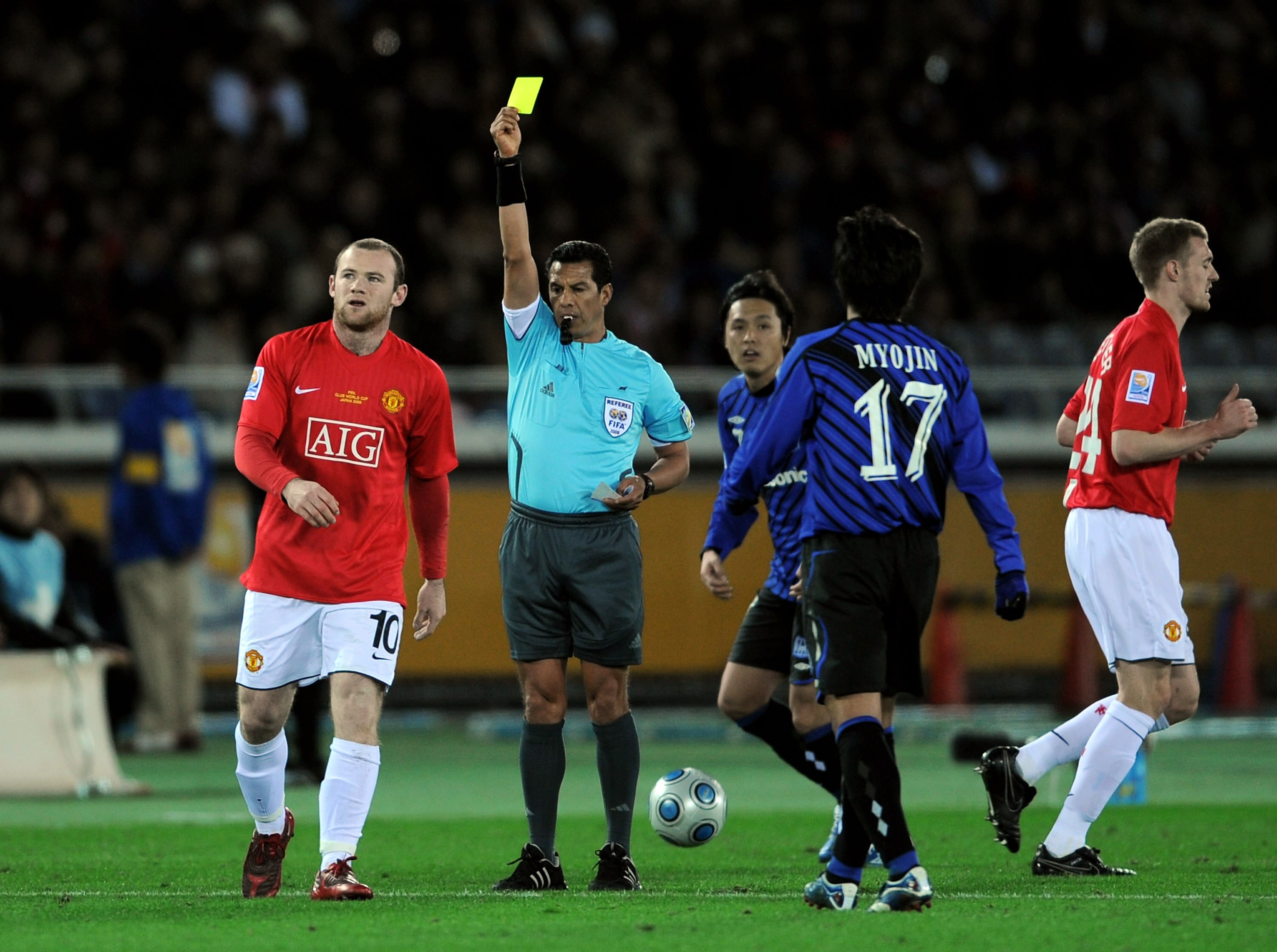 YOKOHAMA, JAPAN - DECEMBER 18:  Wayne Rooney of Manchester United is yellow carded by referee Benito Archundia during the FIFA Club World Cup Japan 2008 Semi Final match between Gamba Osaka and Manchester United  at the International Stadium on December 1