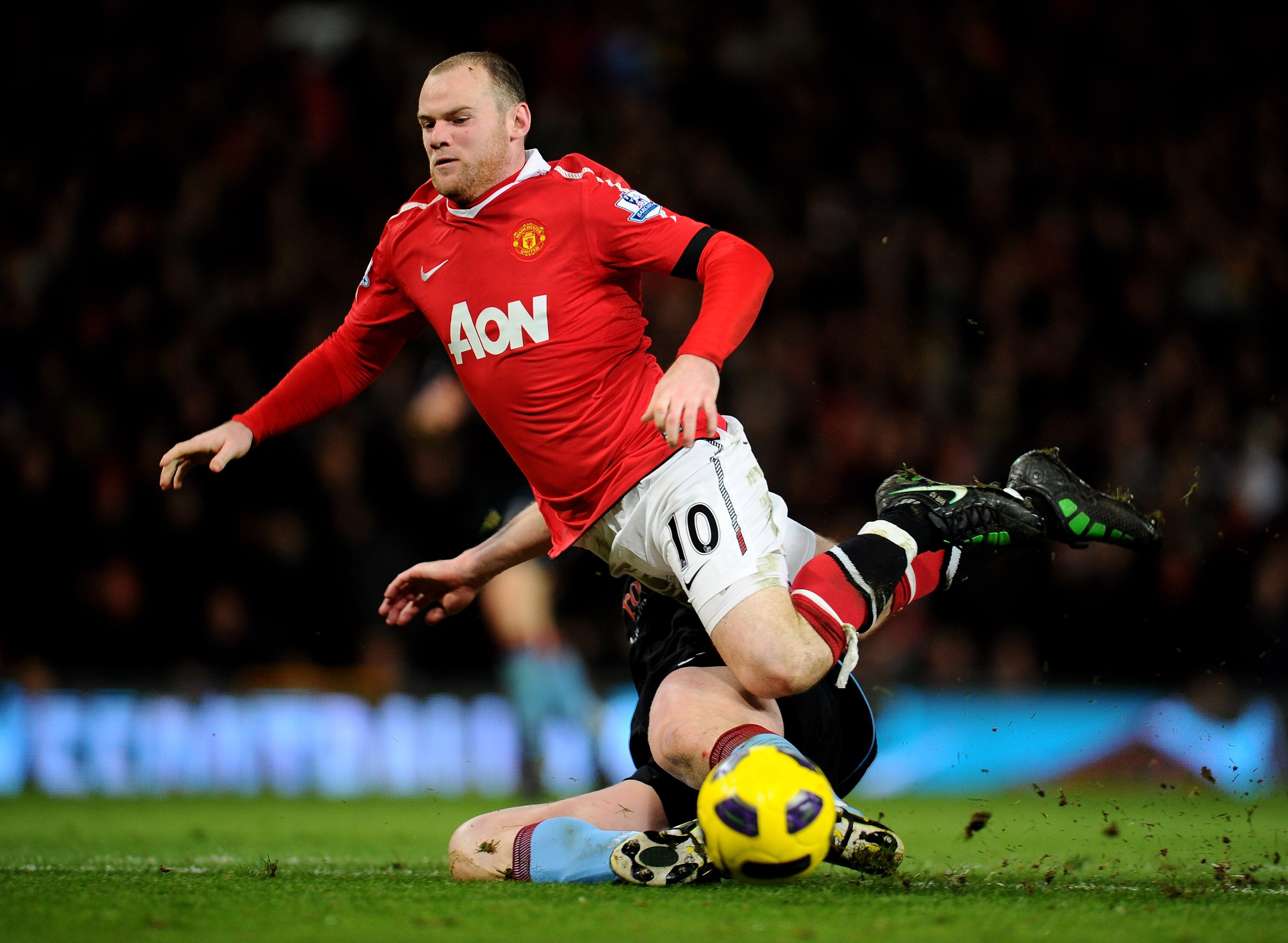 MANCHESTER, ENGLAND - FEBRUARY 01:  Wayne Rooney of Manchester United is tackled by Richard Dunne of Aston Villa during the Barclays Premier League match between Manchester United and Aston Villa at Old Trafford on February 1, 2011 in Manchester, England.