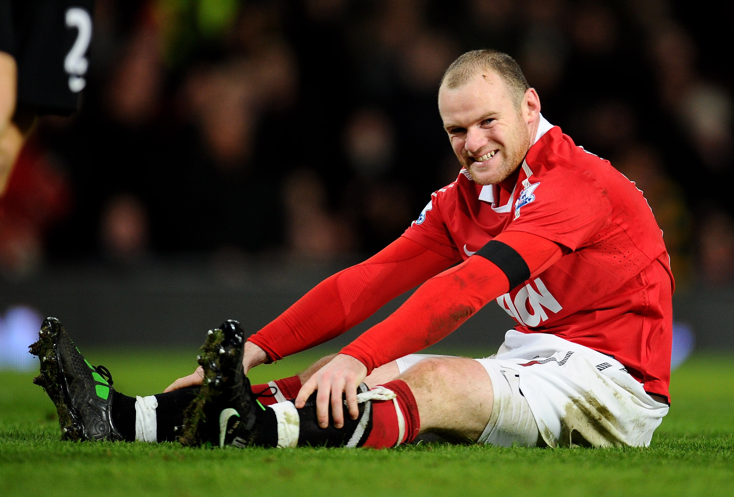 MANCHESTER, ENGLAND - FEBRUARY 01:  Wayne Rooney of Manchester United reacts after being tackled by Richard Dunne of Aston Villa during the Barclays Premier League match between Manchester United and Aston Villa at Old Trafford on February 1, 2011 in Manc