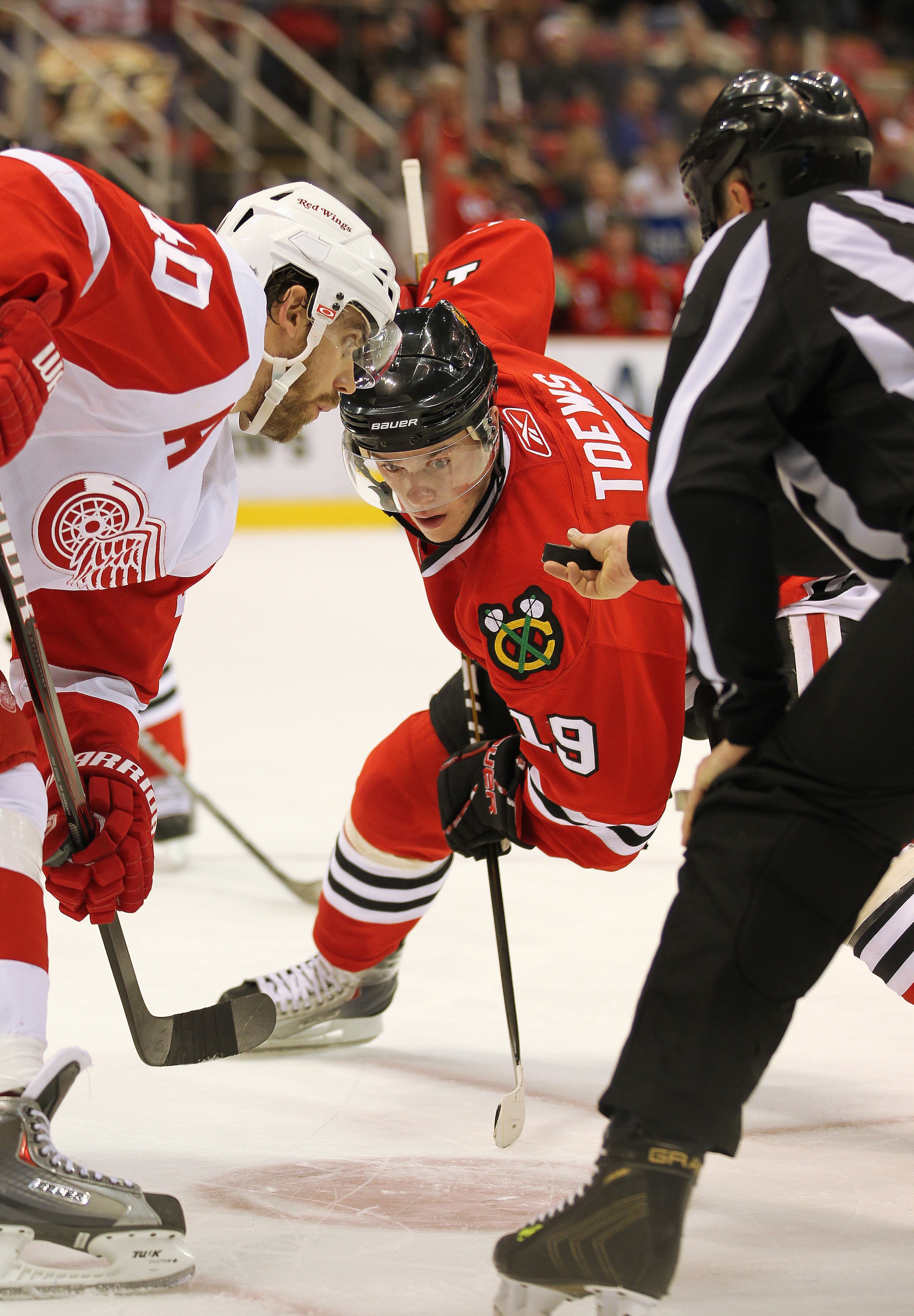 DETROIT, MI - JANUARY 22:  Jonathan Toews #19 of the Chicago Black Hawks takes a faceoff against Henrik Zetterberg #40 of the Detroit Red Wings in a game on January 22, 2011 at the Joe Louis Arena in Detroit, Michigan. The Hawks defeated the Wings 4-1. (P