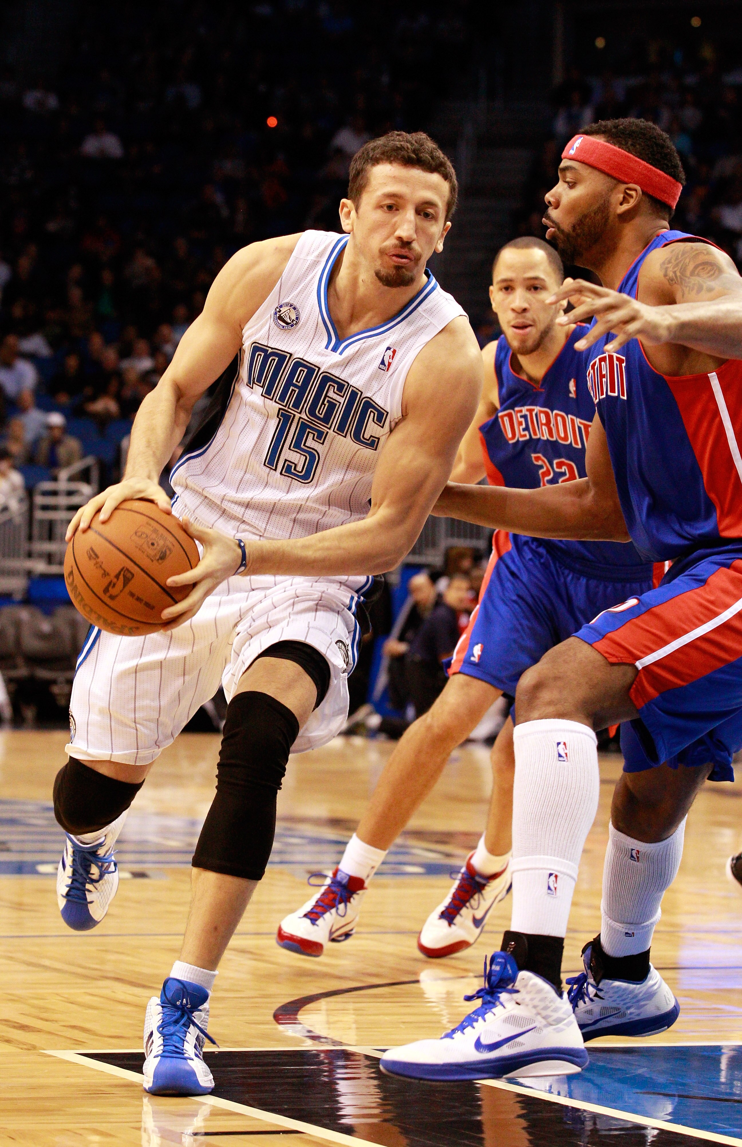 ORLANDO, FL - JANUARY 24:  Hedo Turkoglu #15 of the Orlando Magic drives against Ben Wallace #6 of the Detroit Pistons during the game at Amway Arena on January 24, 2011 in Orlando, Florida.  NOTE TO USER: User expressly acknowledges and agrees that, by d