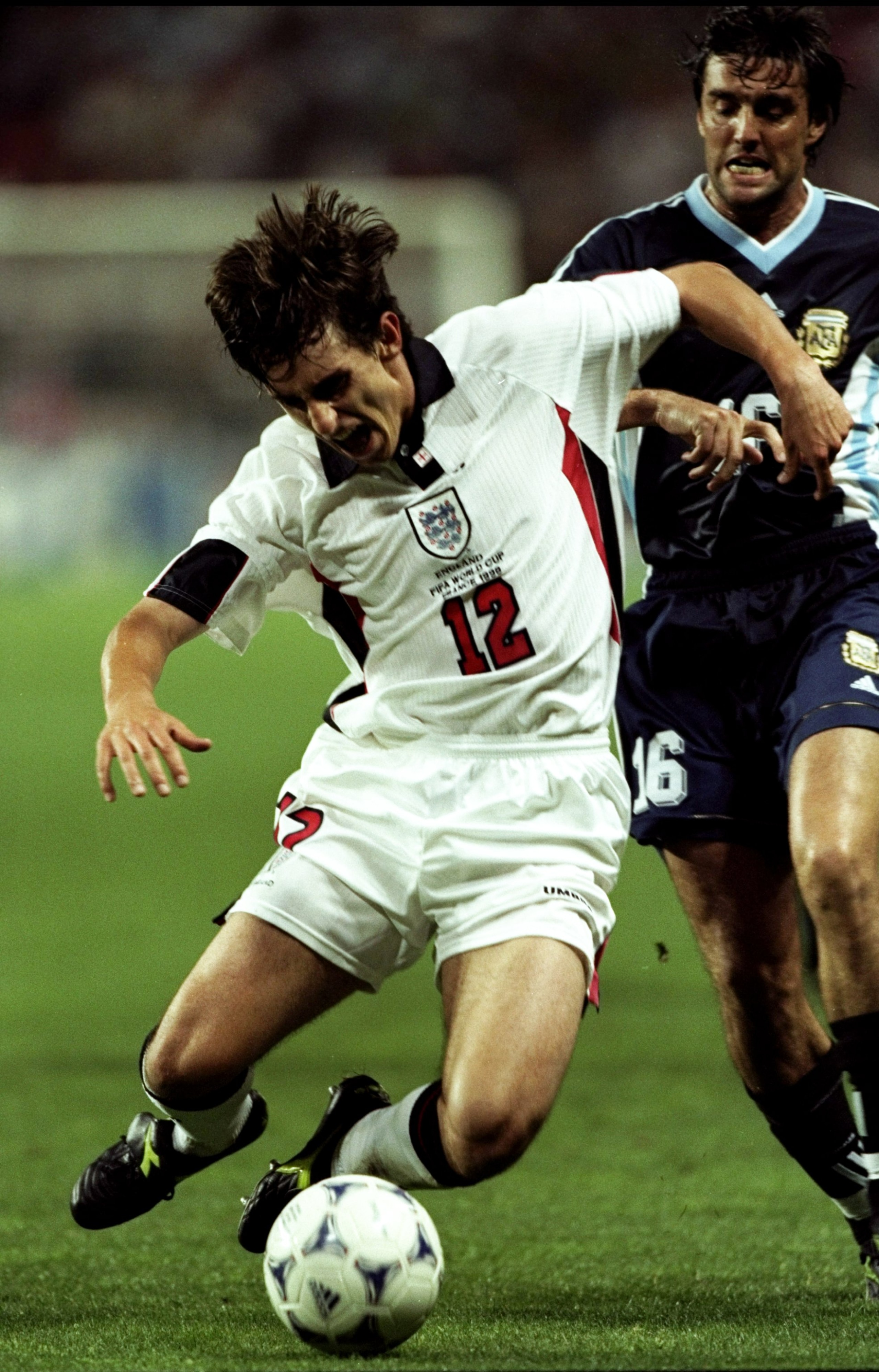 30 Jun 1998:  Gary Neville of England is brought down by Sergio Berti of Argentina during the World Cup second round match at the Stade Geoffroy Guichard in St Etienne, France. England lost 4-3 on penalties after a 2-2 draw. \ Mandatory Credit: Doug Pensi