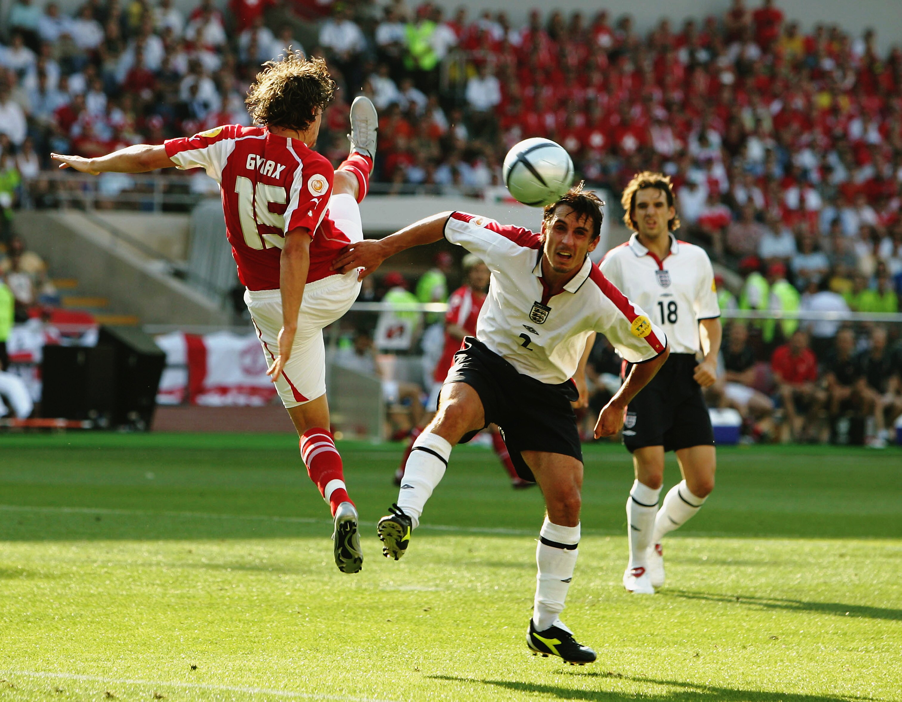 COIMBRA, PORTUGAL - JUNE 17:  Daniel Gygax of Switzerland and Gary Neville of England during the UEFA Euro 2004 Group B match between England and Switzerland on June 17, 2004 at the Estadio Cidade de Coimbra in Coimbra, Portugal. (Photo by Ross Kinnaird/G