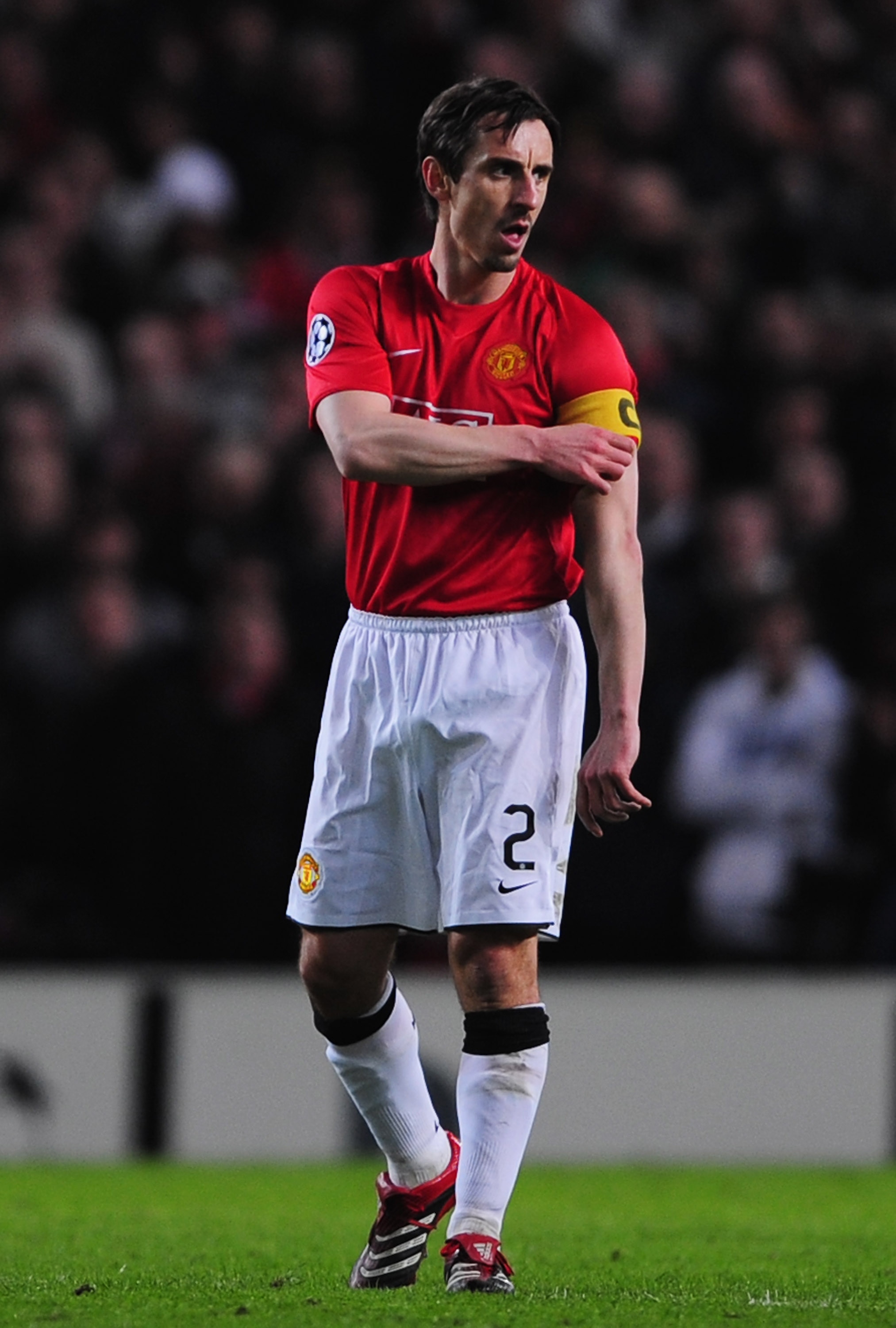 MANCHESTER, UNITED KINGDOM - APRIL 09:  Gary Neville of Manchester United dons the captain's armband as he comes on as a substitute during the UEFA Champions League Quarter Final 2nd leg match between Manchester United and AS Roma at Old Trafford on April