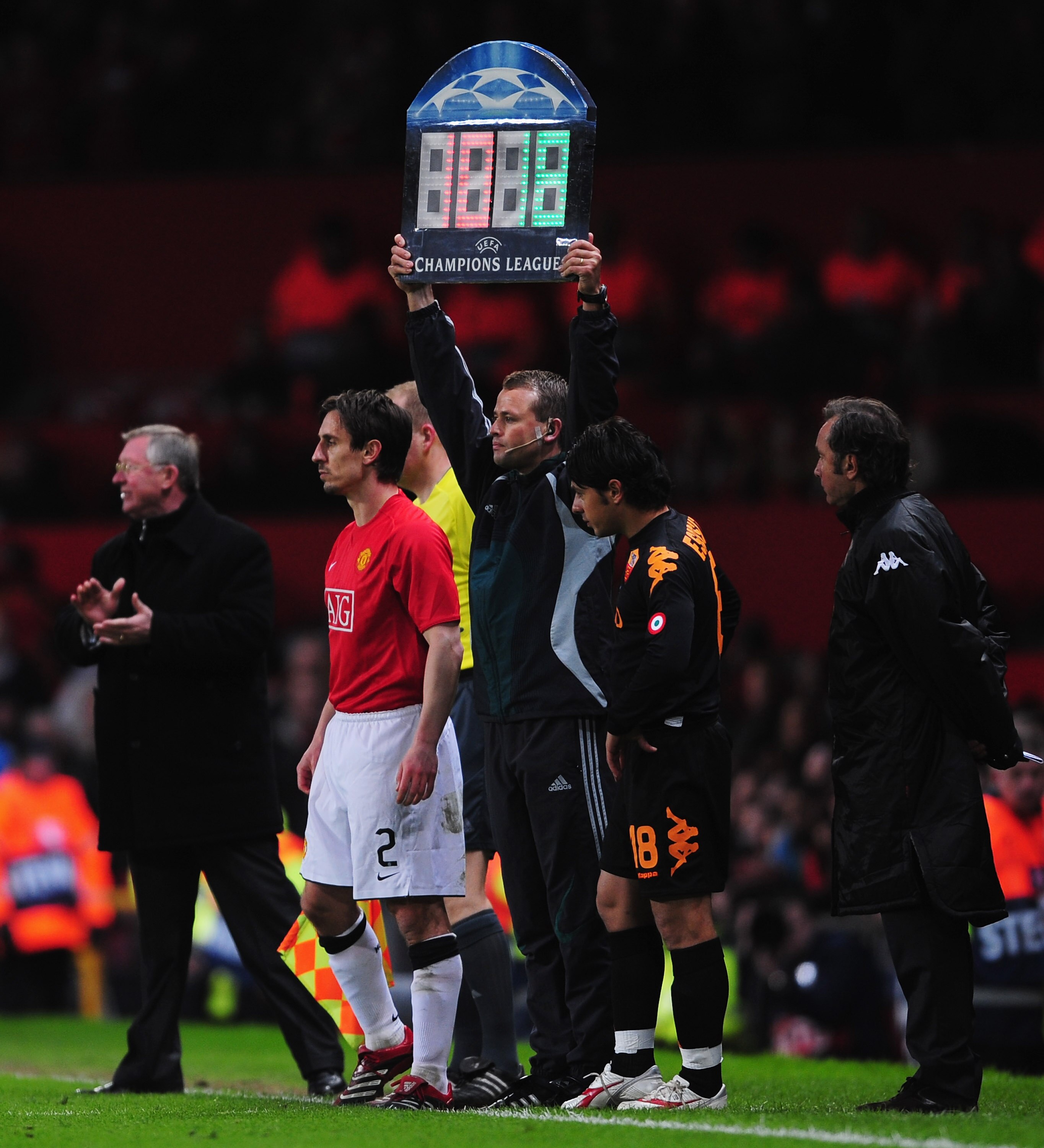 MANCHESTER, UNITED KINGDOM - APRIL 09:  Gary Neville of Manchester United (2L) is applauded by manager Sir Alex Ferguson (L) comes on as a substitute during the UEFA Champions League Quarter Final 2nd leg match between Manchester United and AS Roma at Old