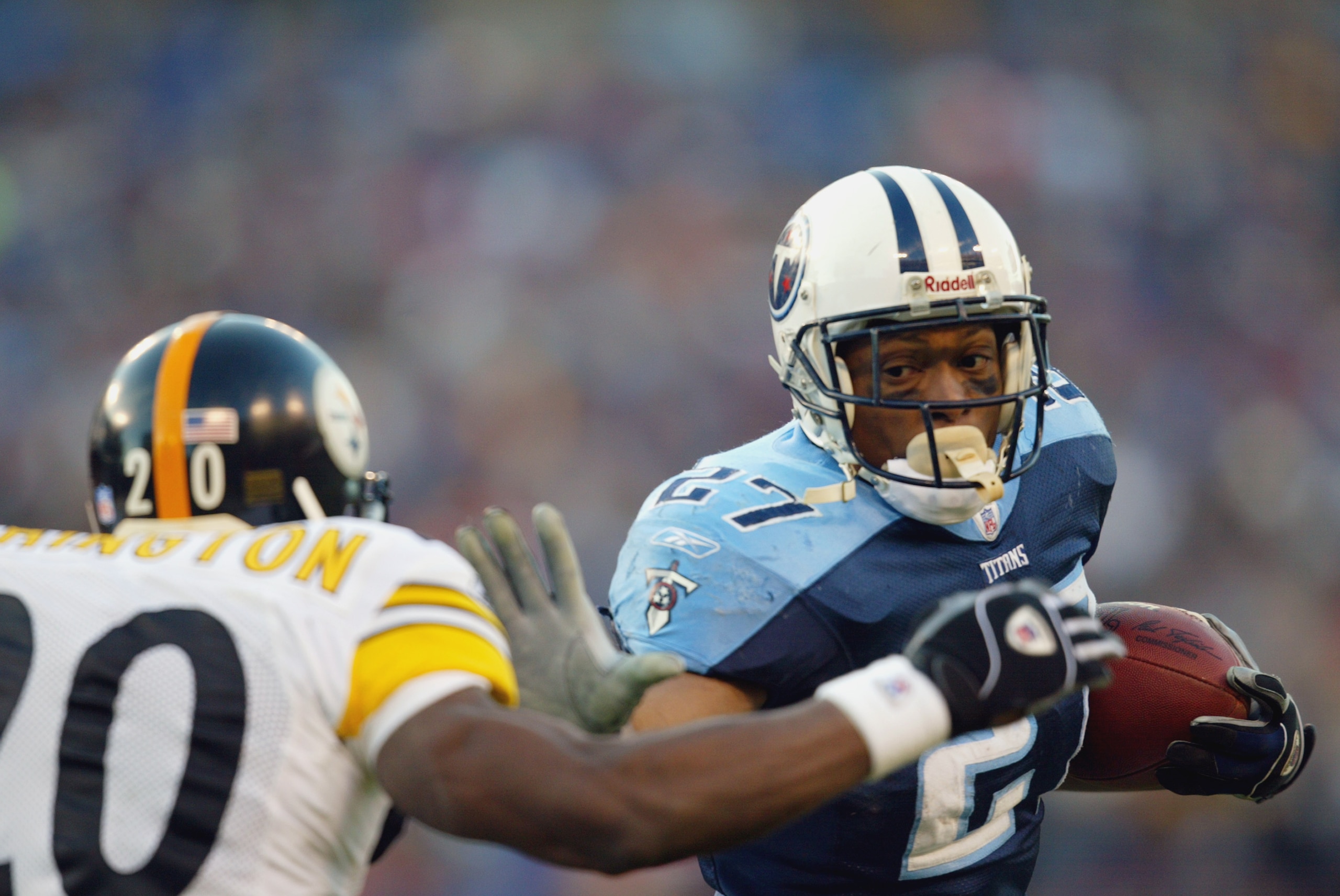 NASHVILLE, TN - JANUARY 11:   Eddie George #27 of the Tennessee Titans stiffarms Dewayne Washington #20 of the Pittsburgh Steelers during the first half of the AFC Divisional playoff game at The Coliseum on January 11, 2003 in Nashville, Tennessee.  The T